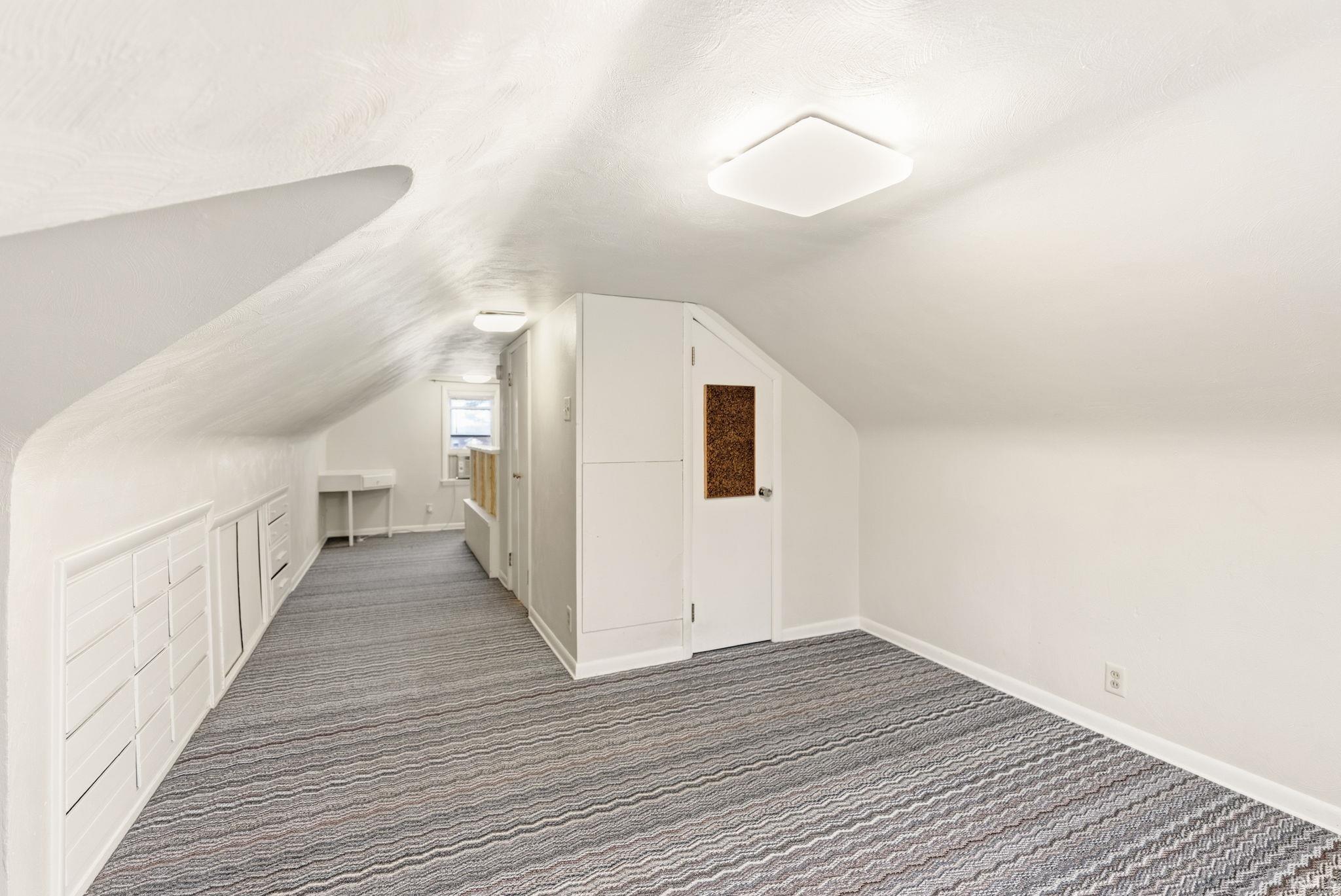 Additional living space featuring carpet floors and baseboards