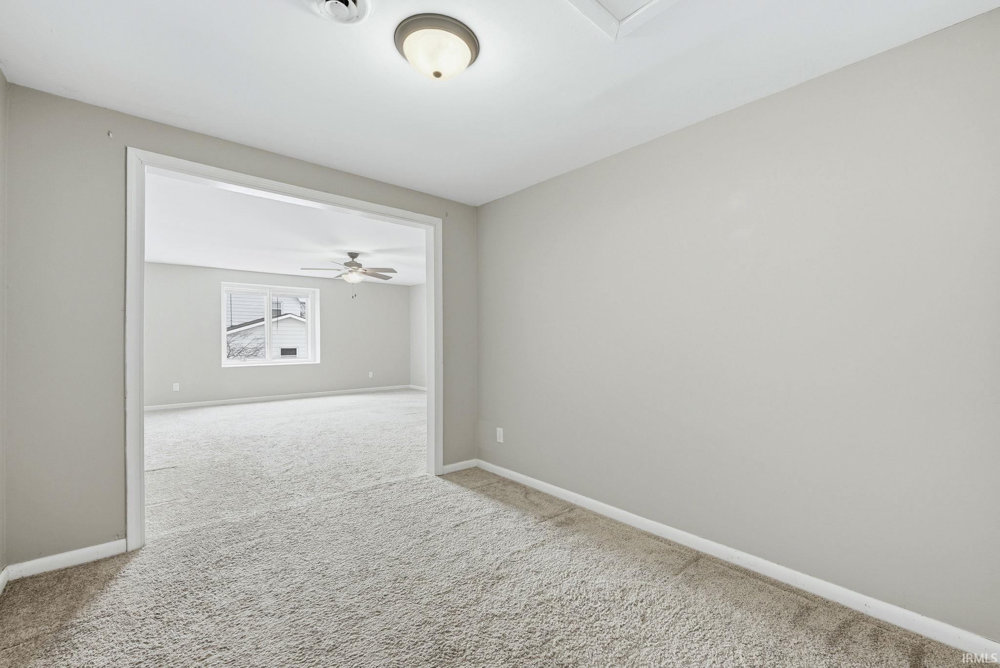 Unfurnished room with baseboards and carpet