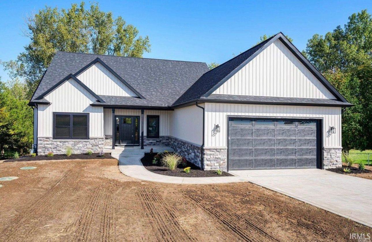 Modern farmhouse featuring stone siding, an attached garage, driveway, and roof with shingles