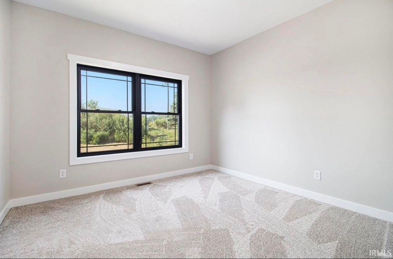 Spare room with baseboards and carpet floors