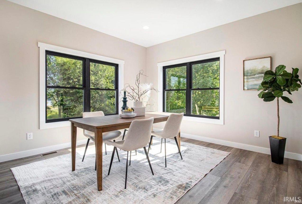 Dining space featuring plenty of natural light, wood finished floors, and recessed lighting