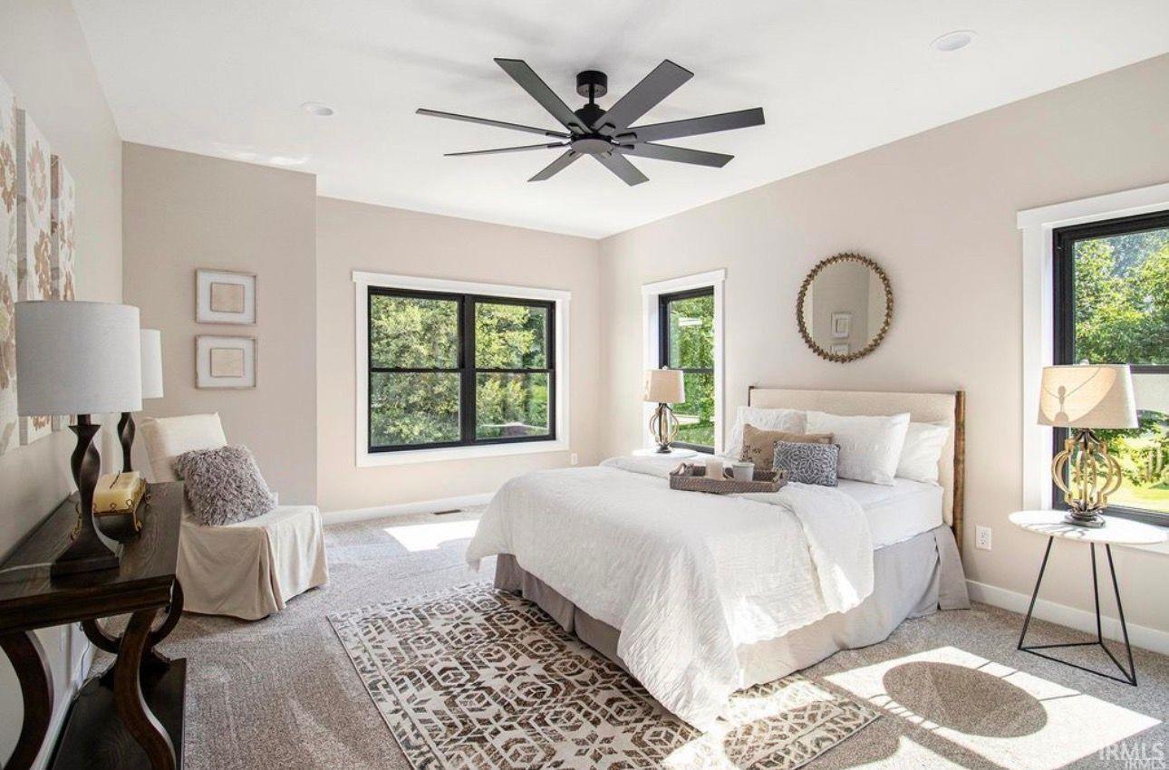 Carpeted bedroom with baseboards and ceiling fan