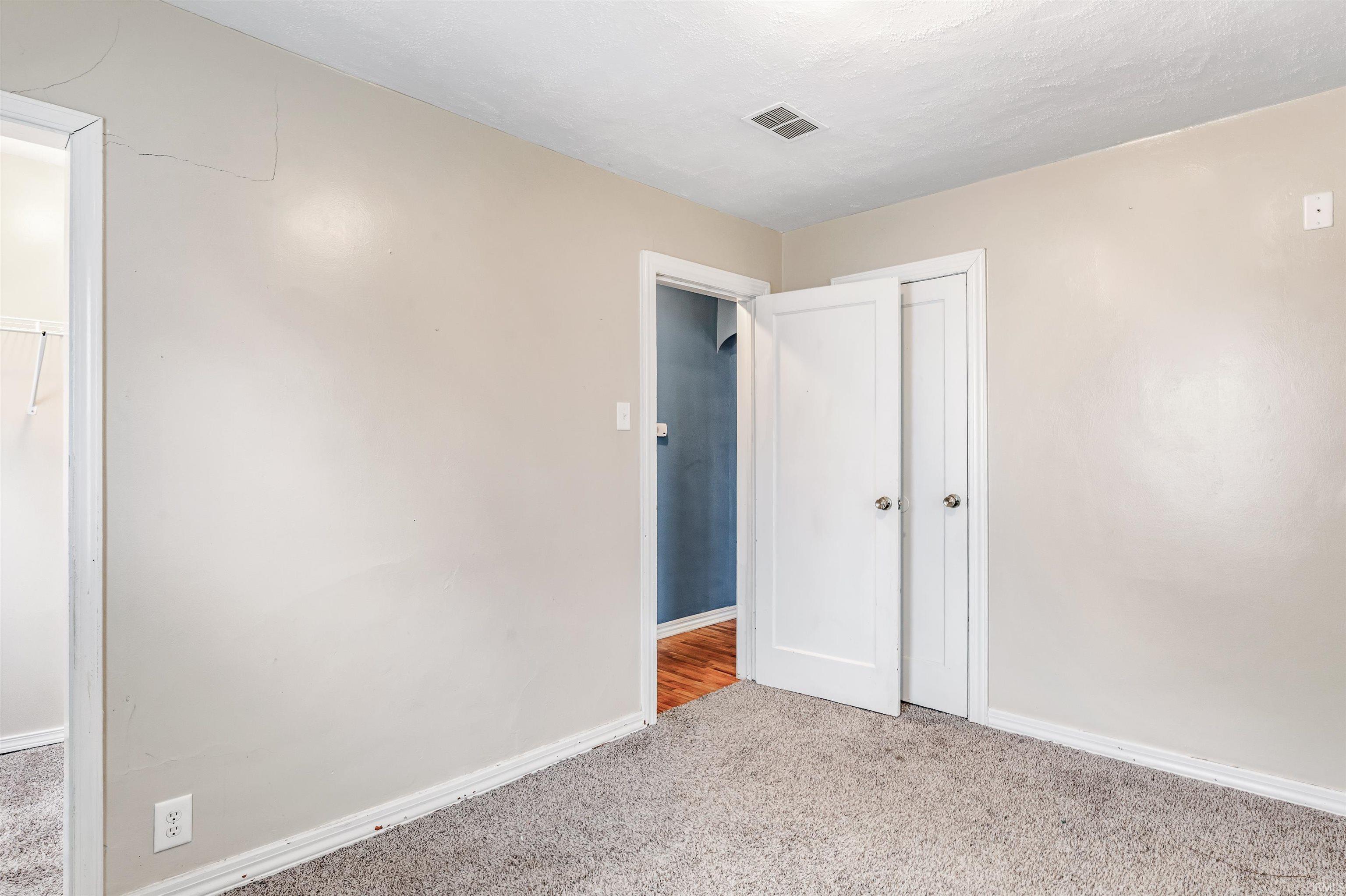 Unfurnished bedroom featuring carpet and a closet