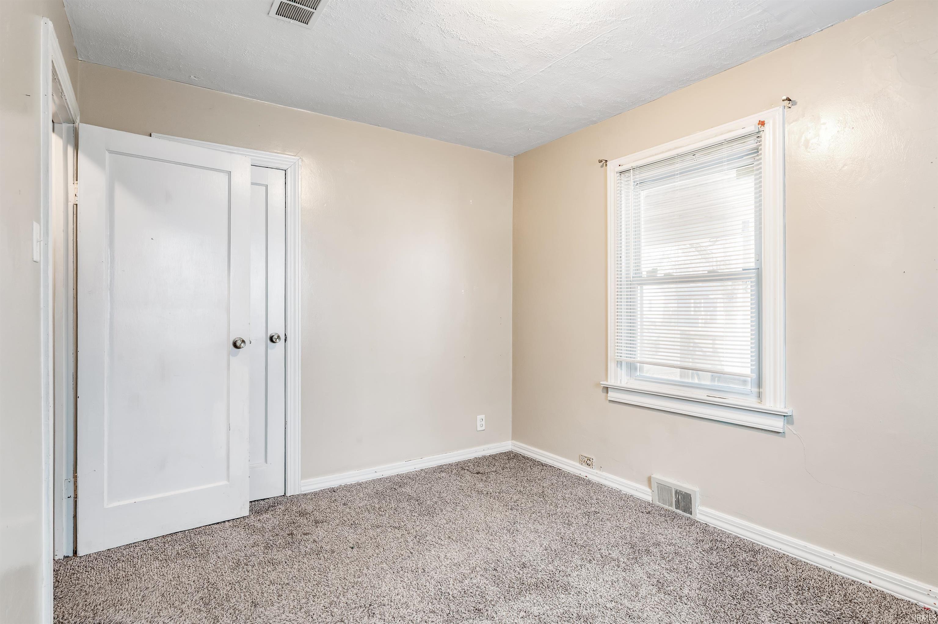 Unfurnished bedroom featuring carpet floors and baseboards
