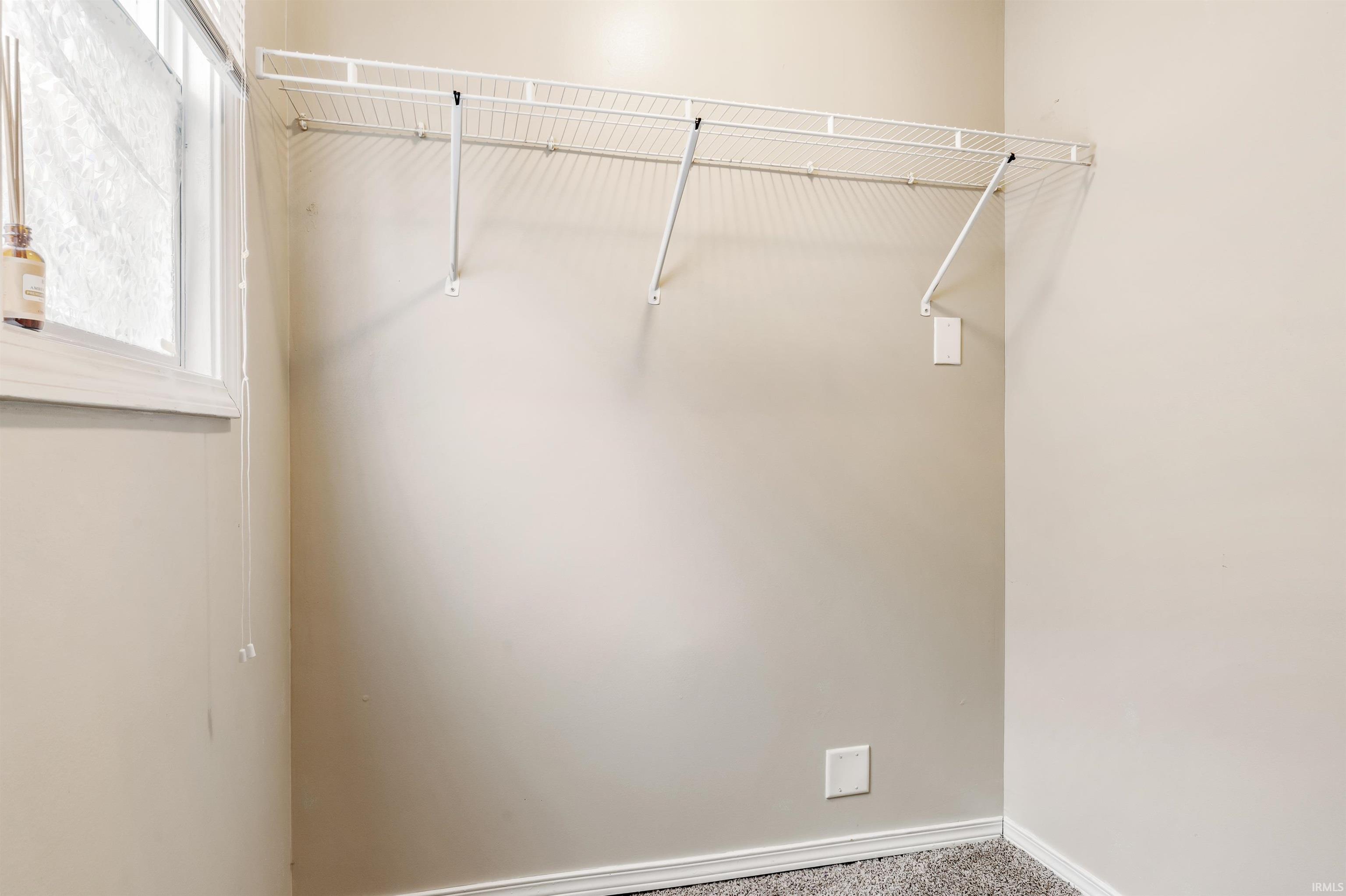 Walk in closet featuring carpet flooring