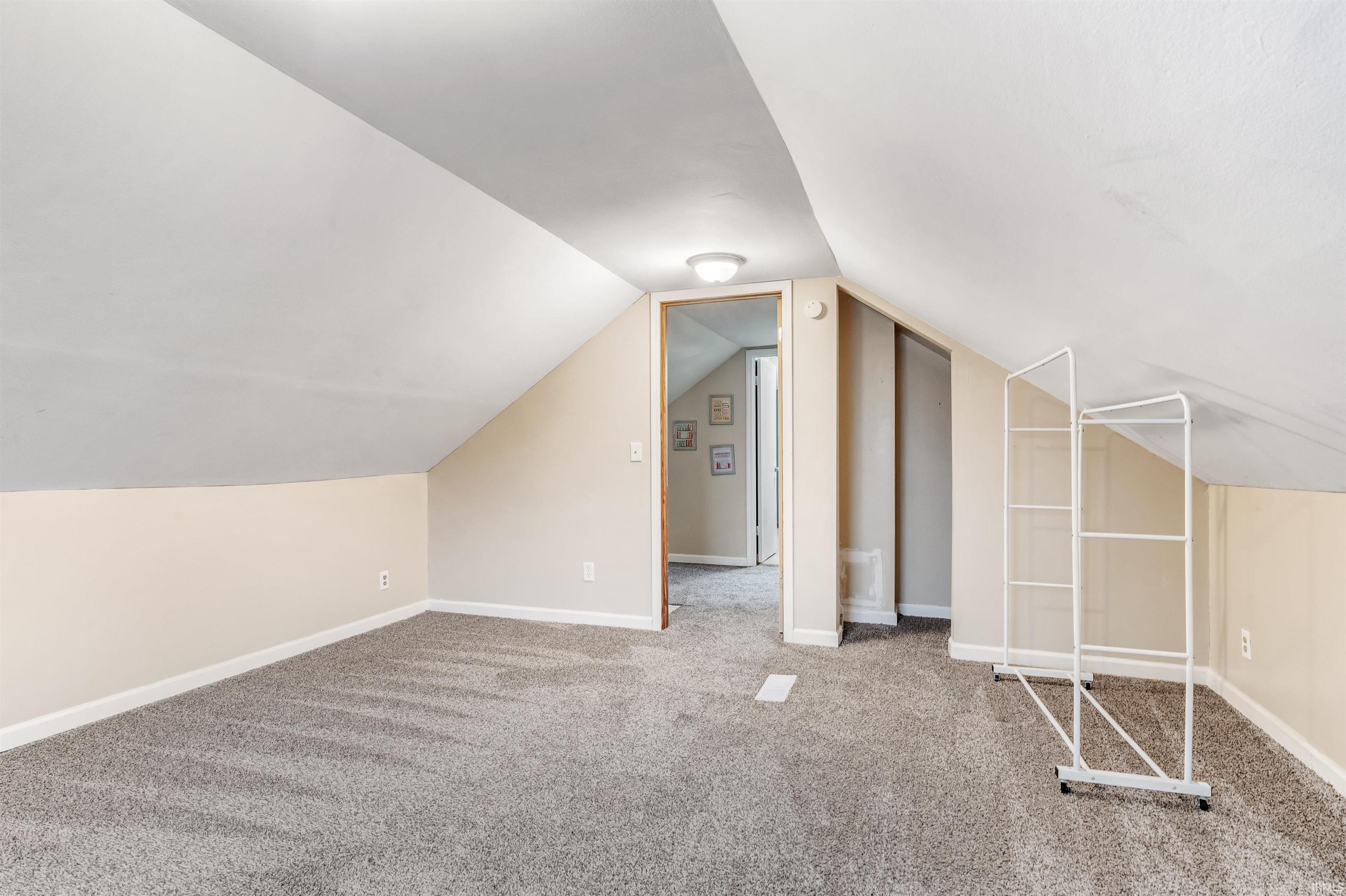 Bonus room featuring carpet flooring and baseboards