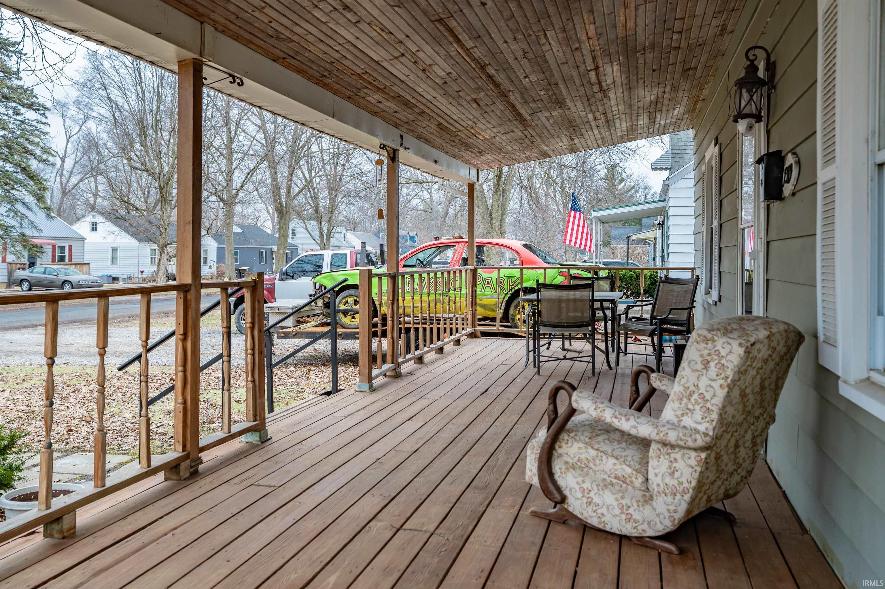 Porch with a residential view and outdoor dining space