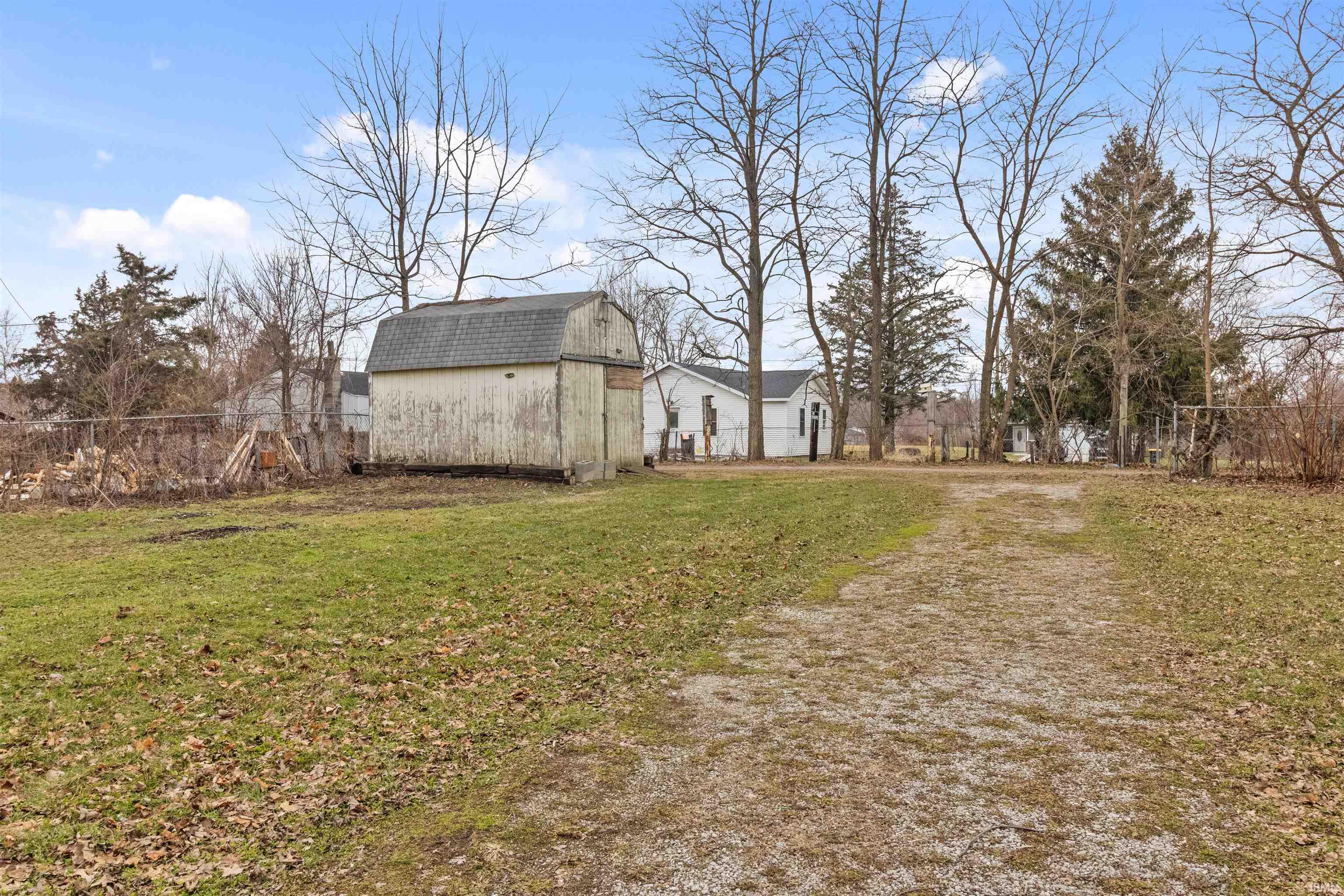 View of yard featuring a barn and an outdoor structure