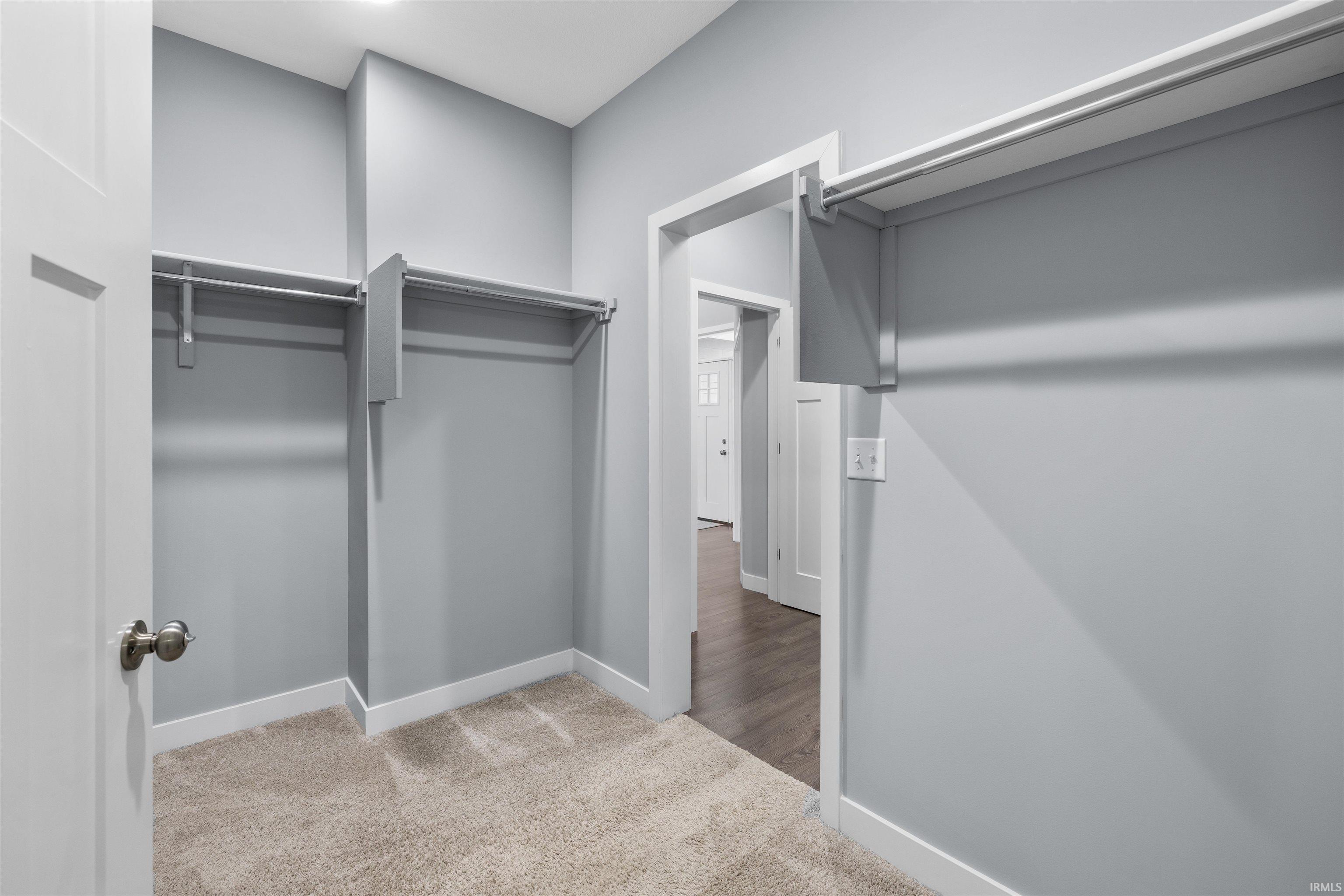 Walk in closet with light carpet