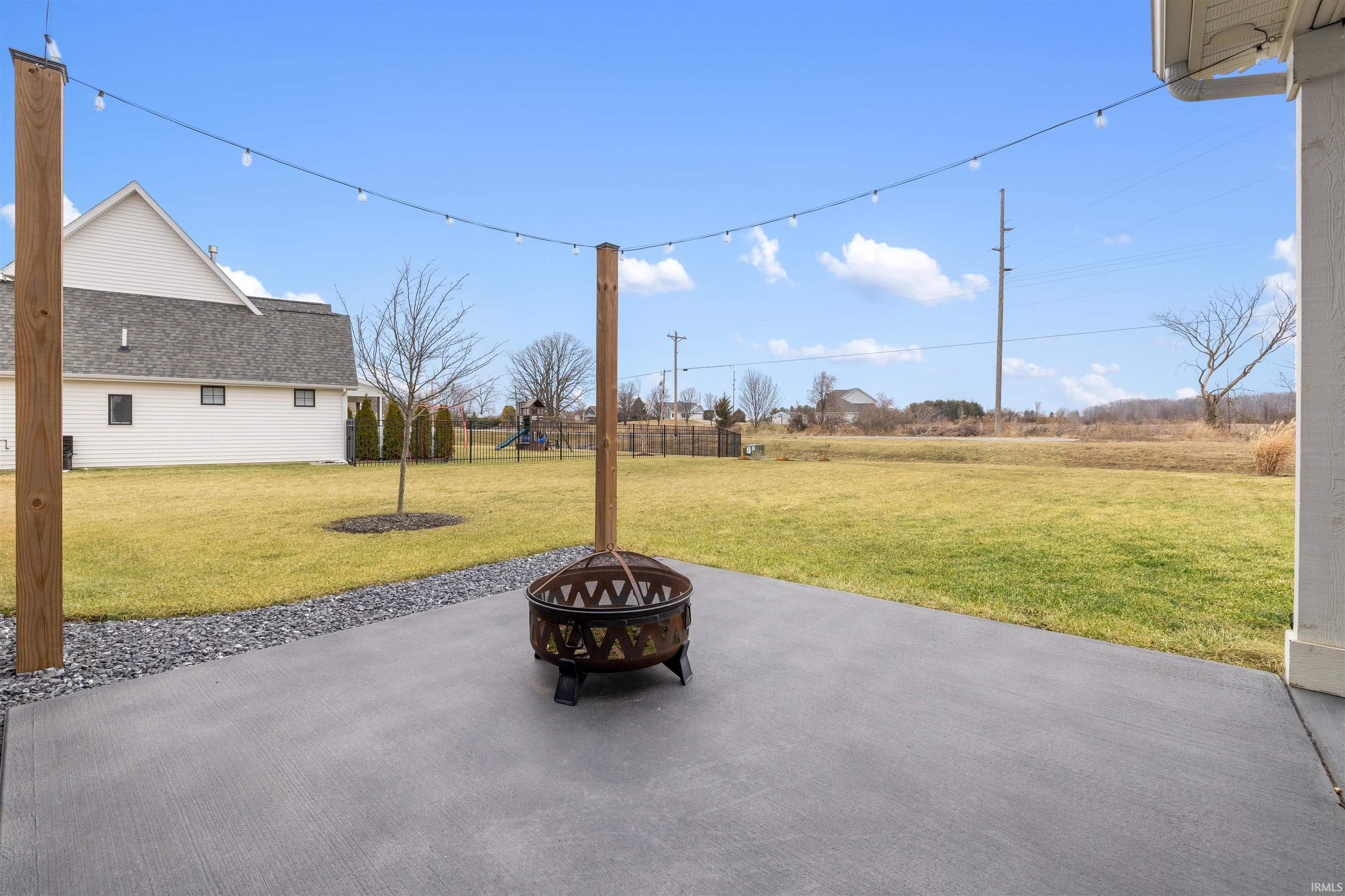 View of patio with an outdoor fire pit