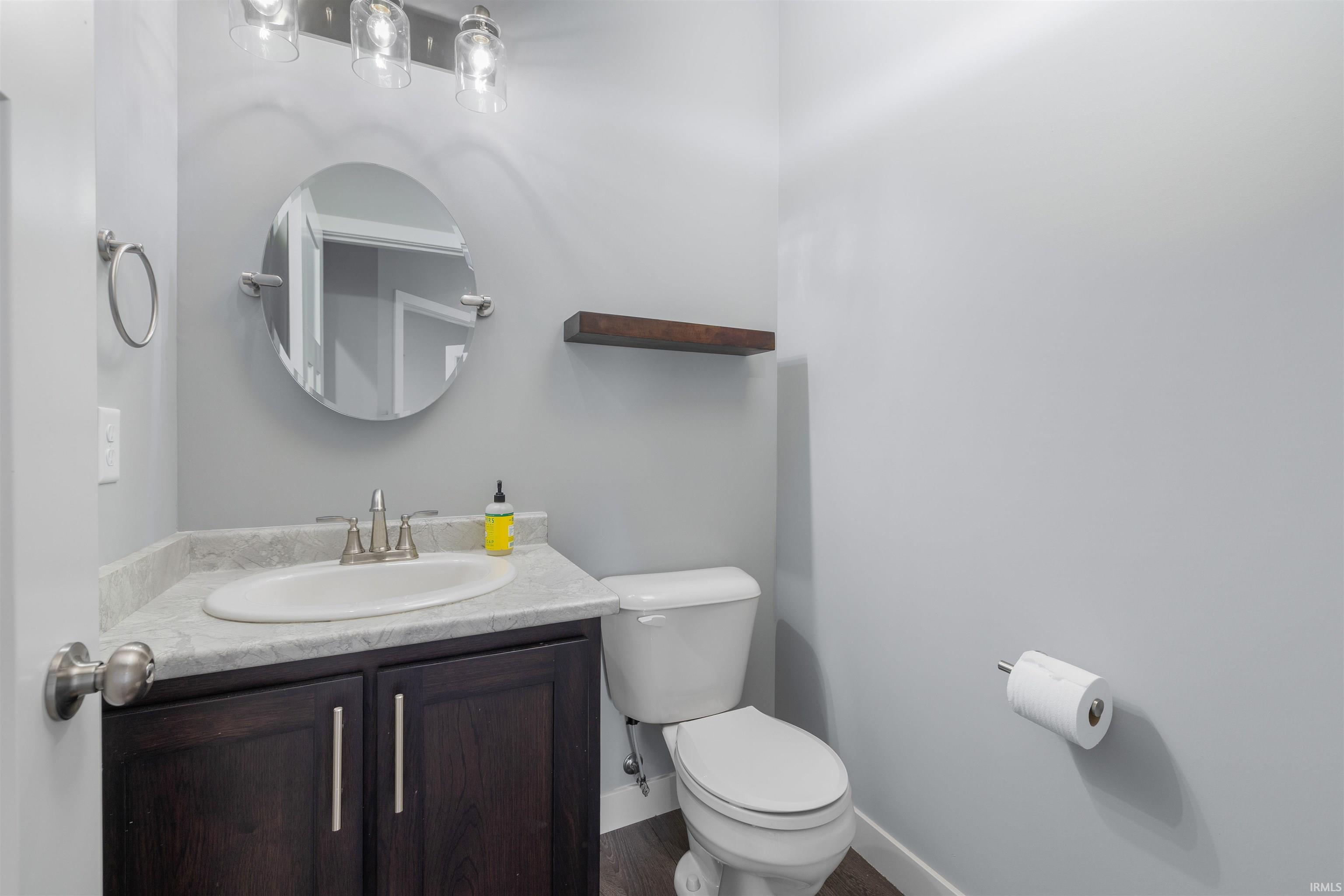 Half bath featuring vanity and toilet