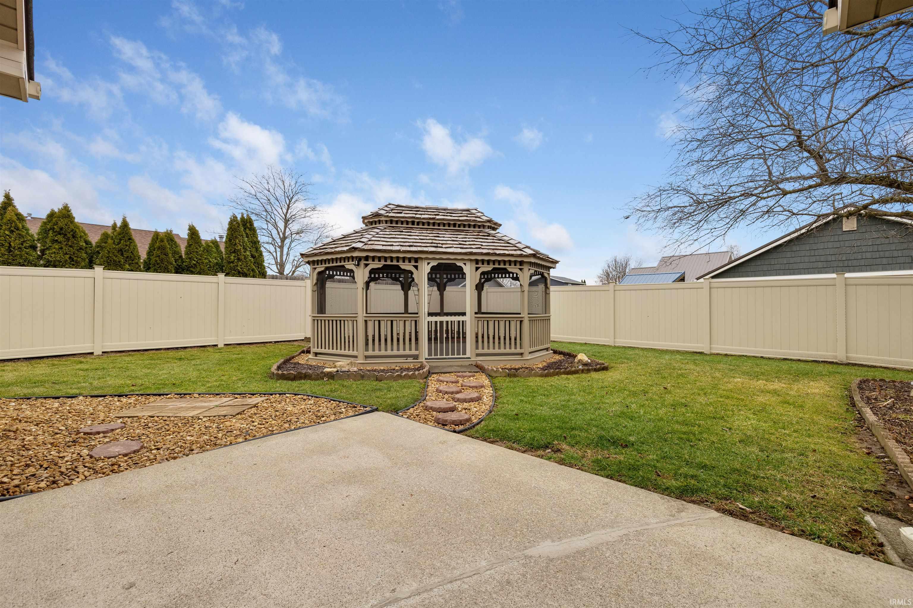 Fenced backyard with a gazebo and a patio