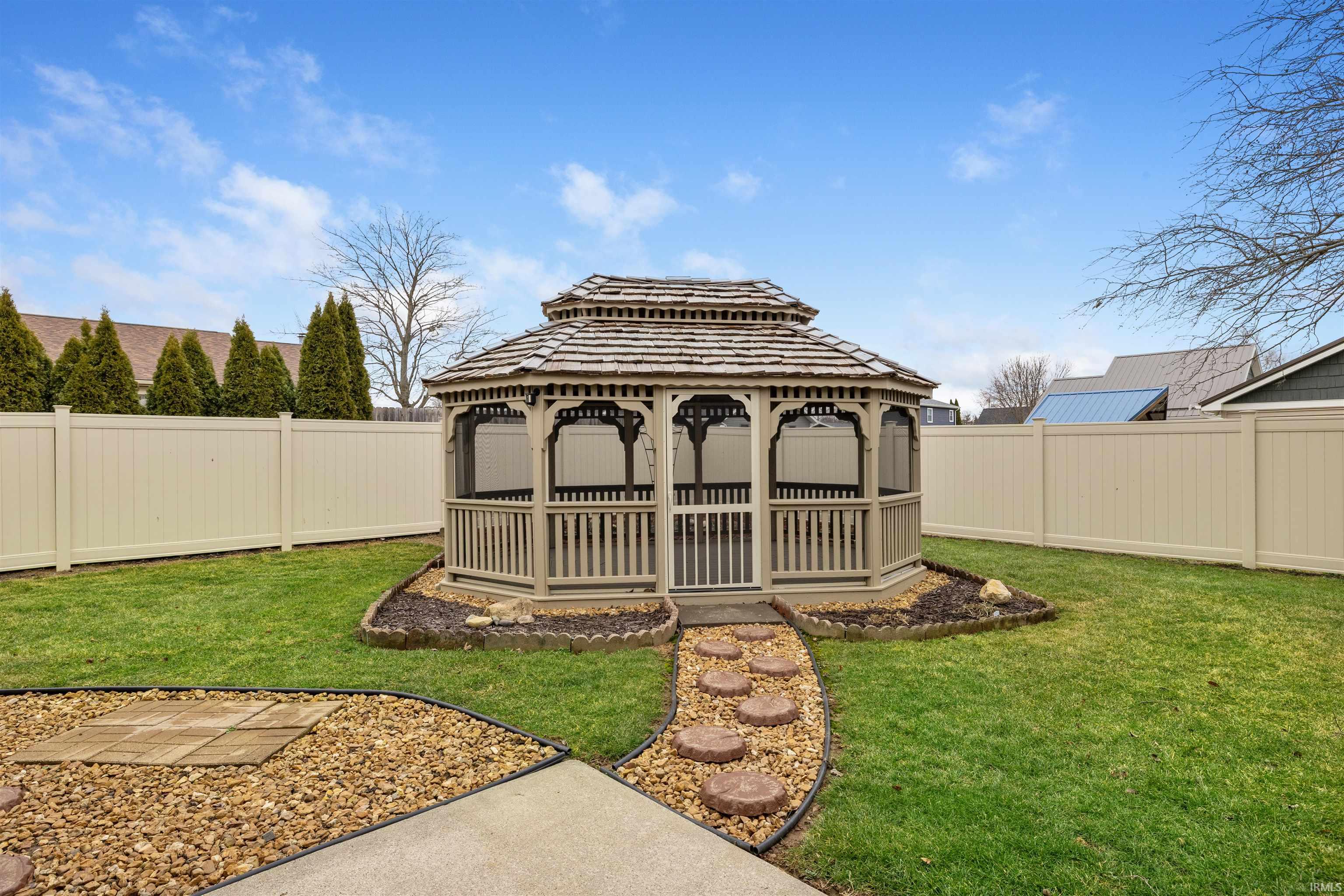Fenced backyard with a gazebo and a patio