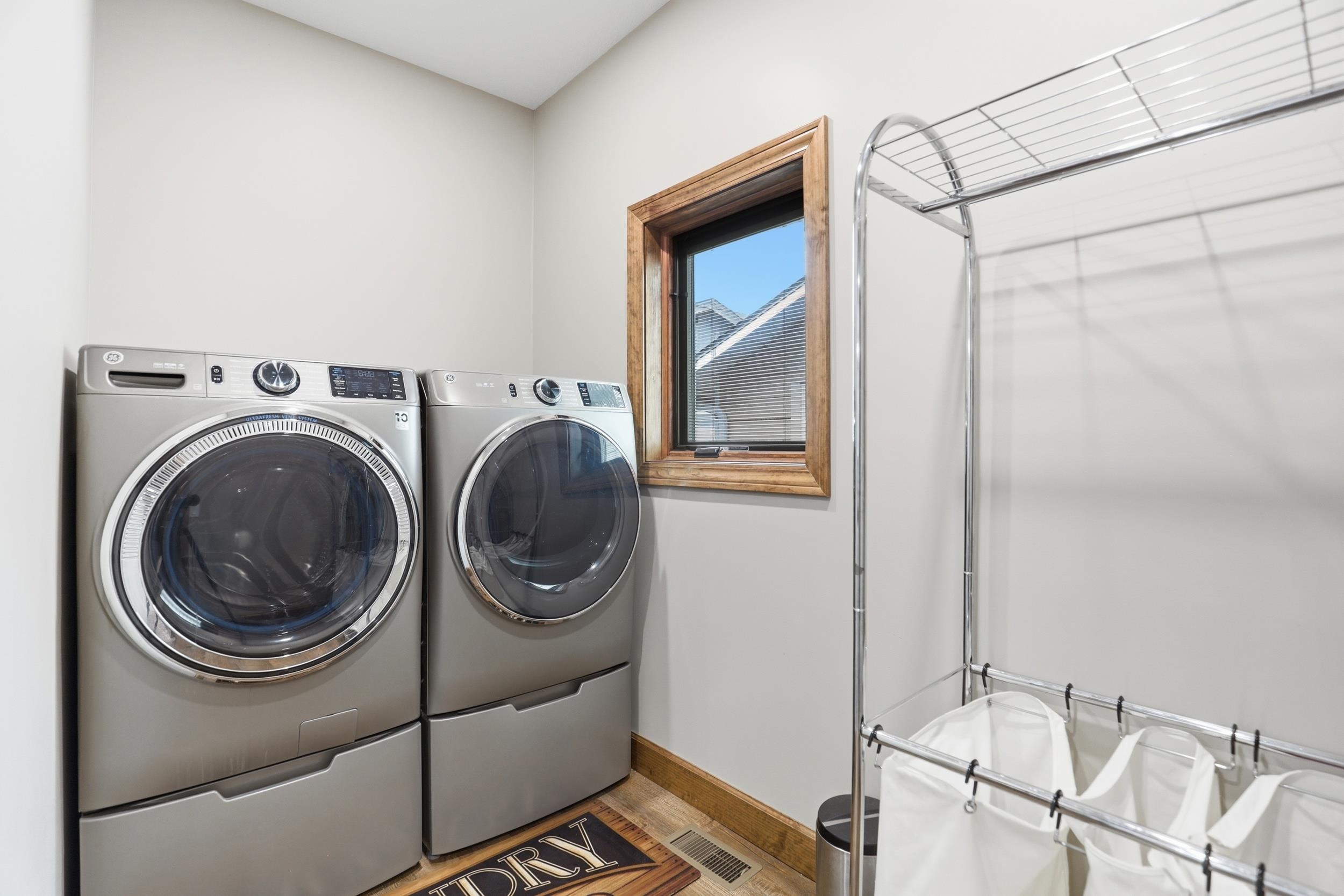 Laundry area featuring baseboards and separate washer and dryer