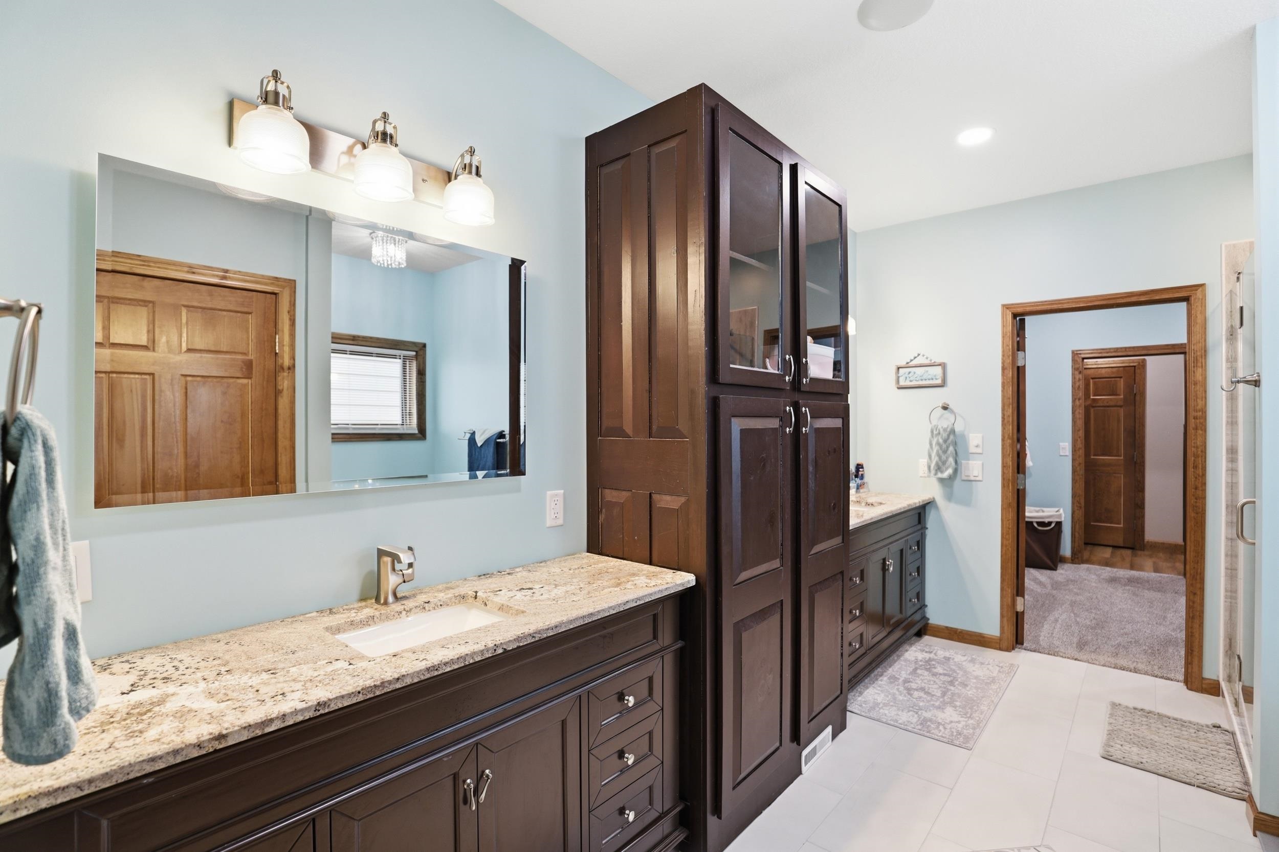 Bathroom with two vanities and a shower stall