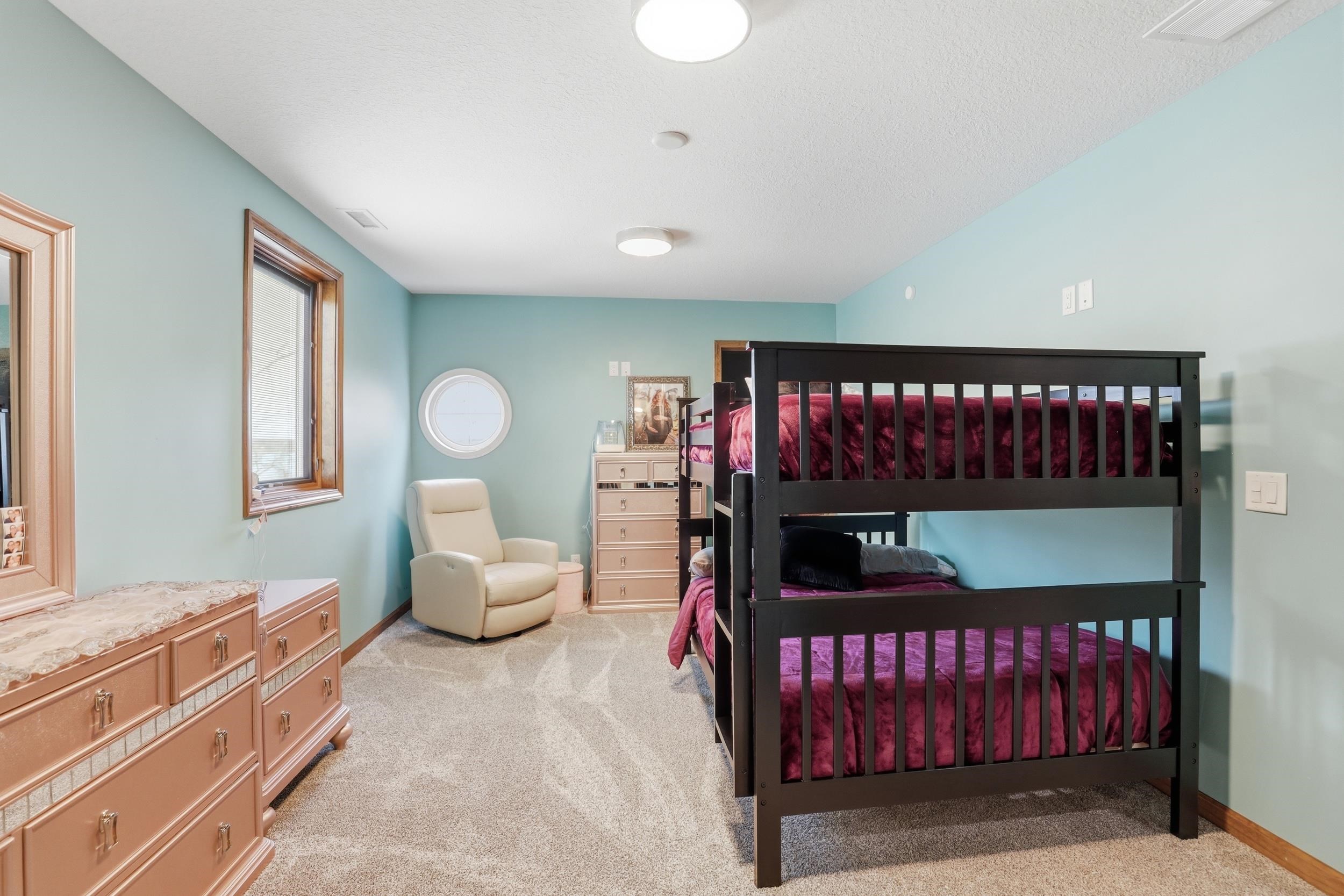 Bedroom featuring light colored carpet