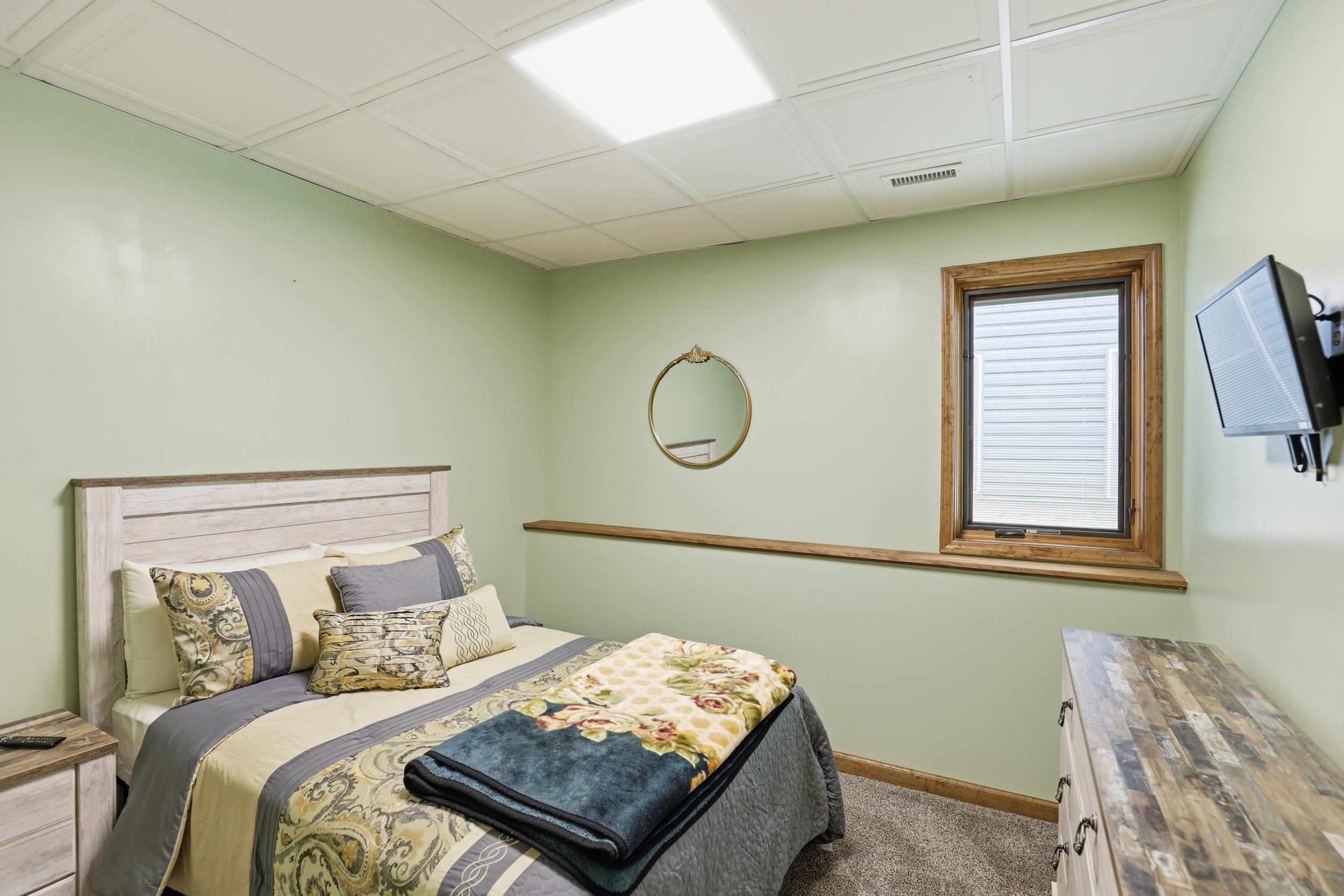 Bedroom featuring baseboards and dark carpet
