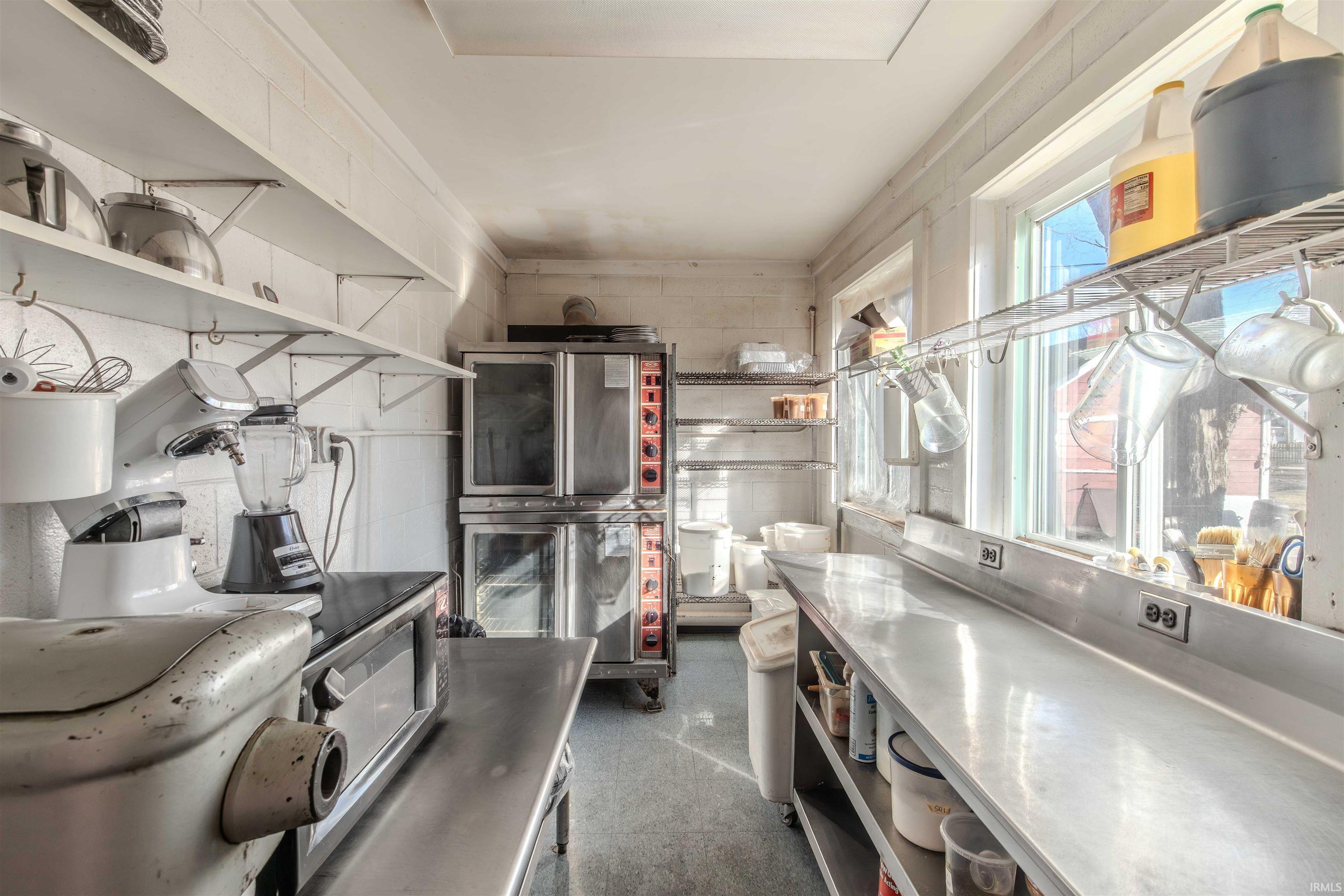 Kitchen with stainless steel countertops and open shelves