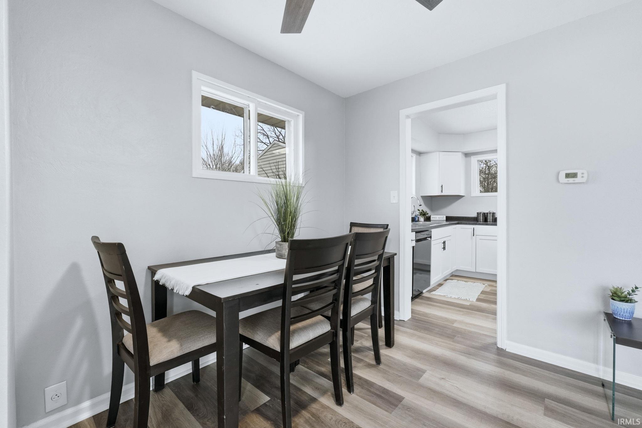 Dining area with light wood finished floors and a ceiling fan