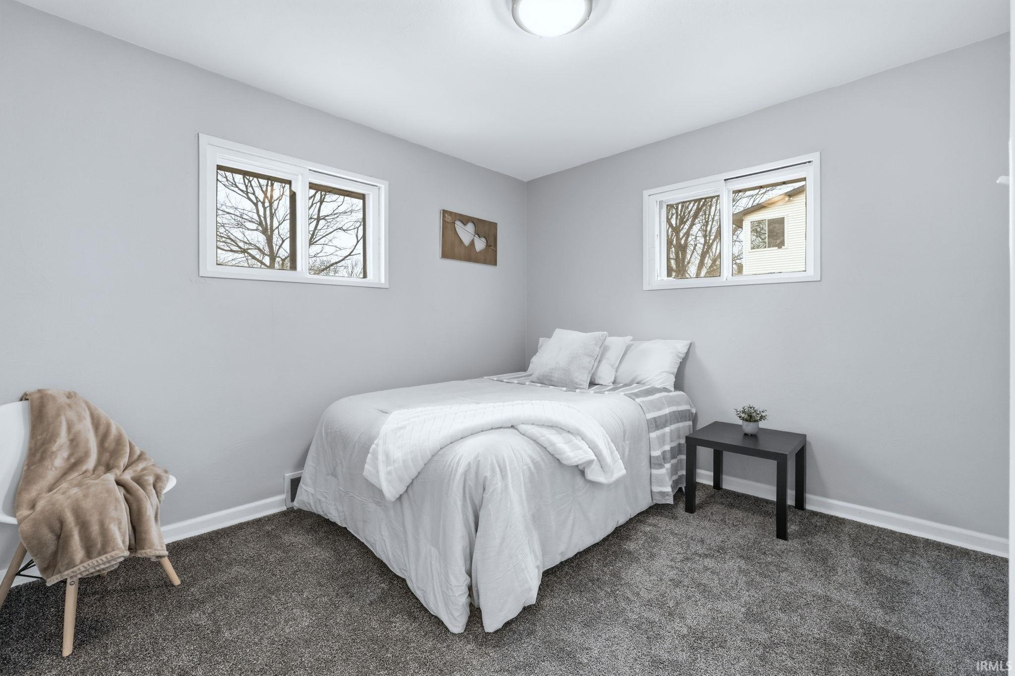 Bedroom featuring baseboards and carpet flooring