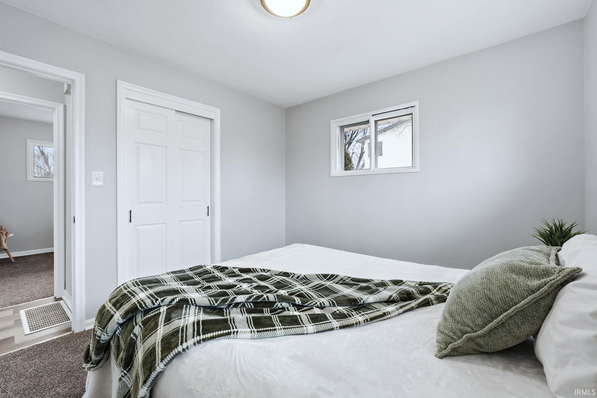 Bedroom featuring carpet and a closet