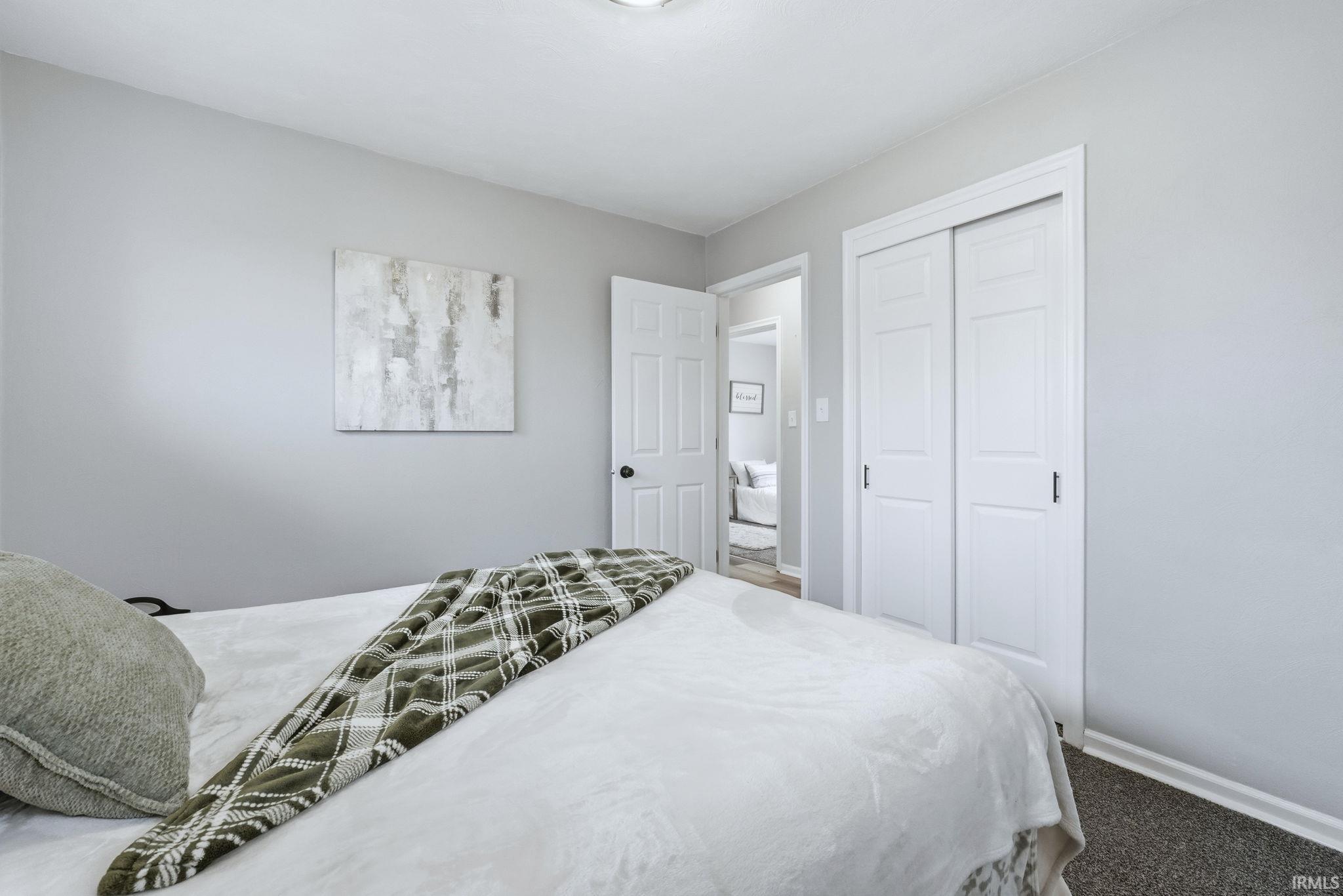 Bedroom with a closet and carpet flooring