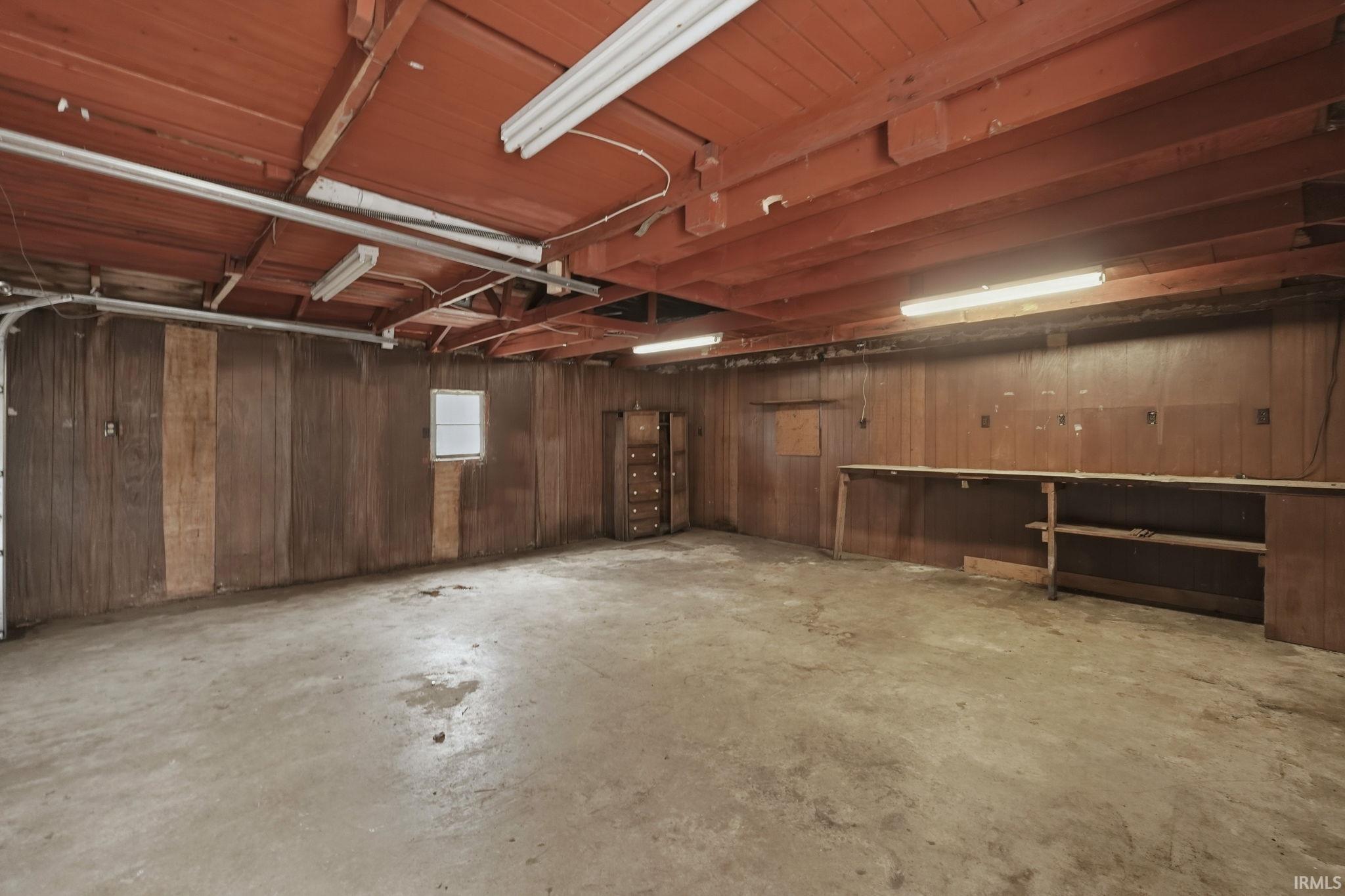 Garage featuring wooden walls