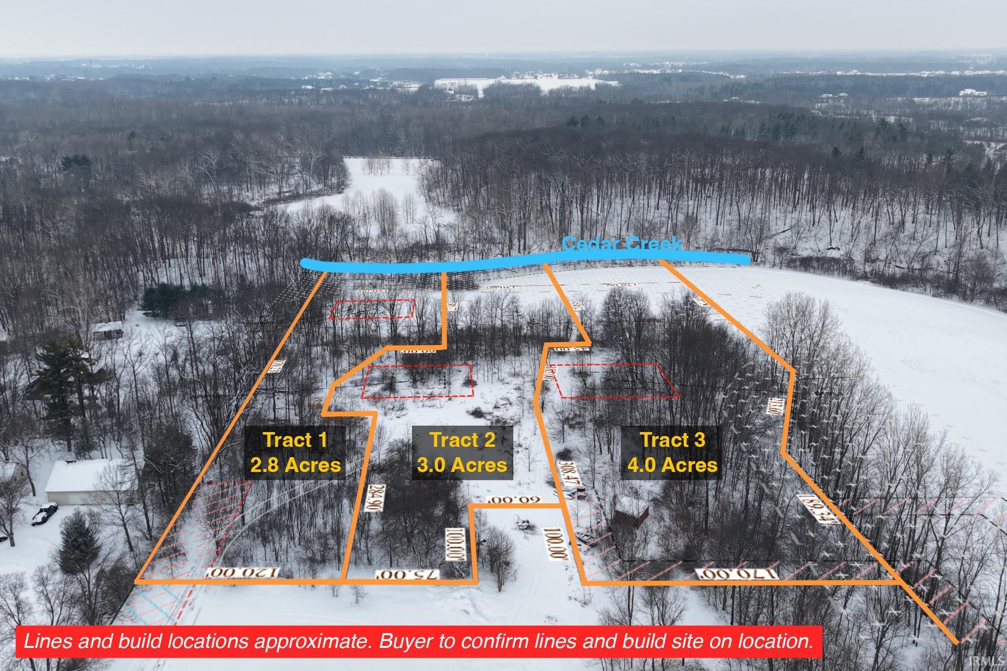 Aerial view of property's location featuring property parcel outlined and a forest