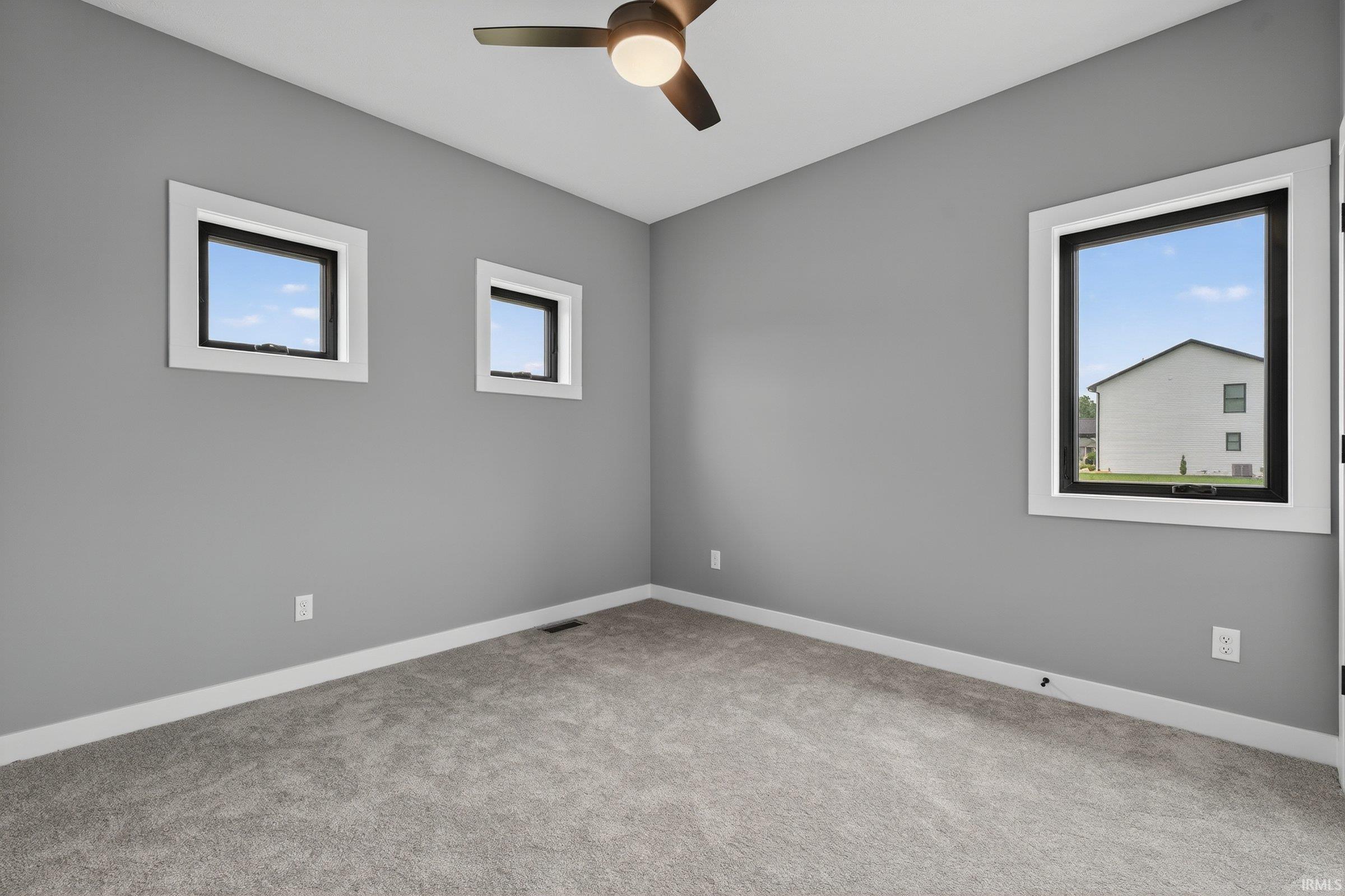 Spare room with light carpet and ceiling fan