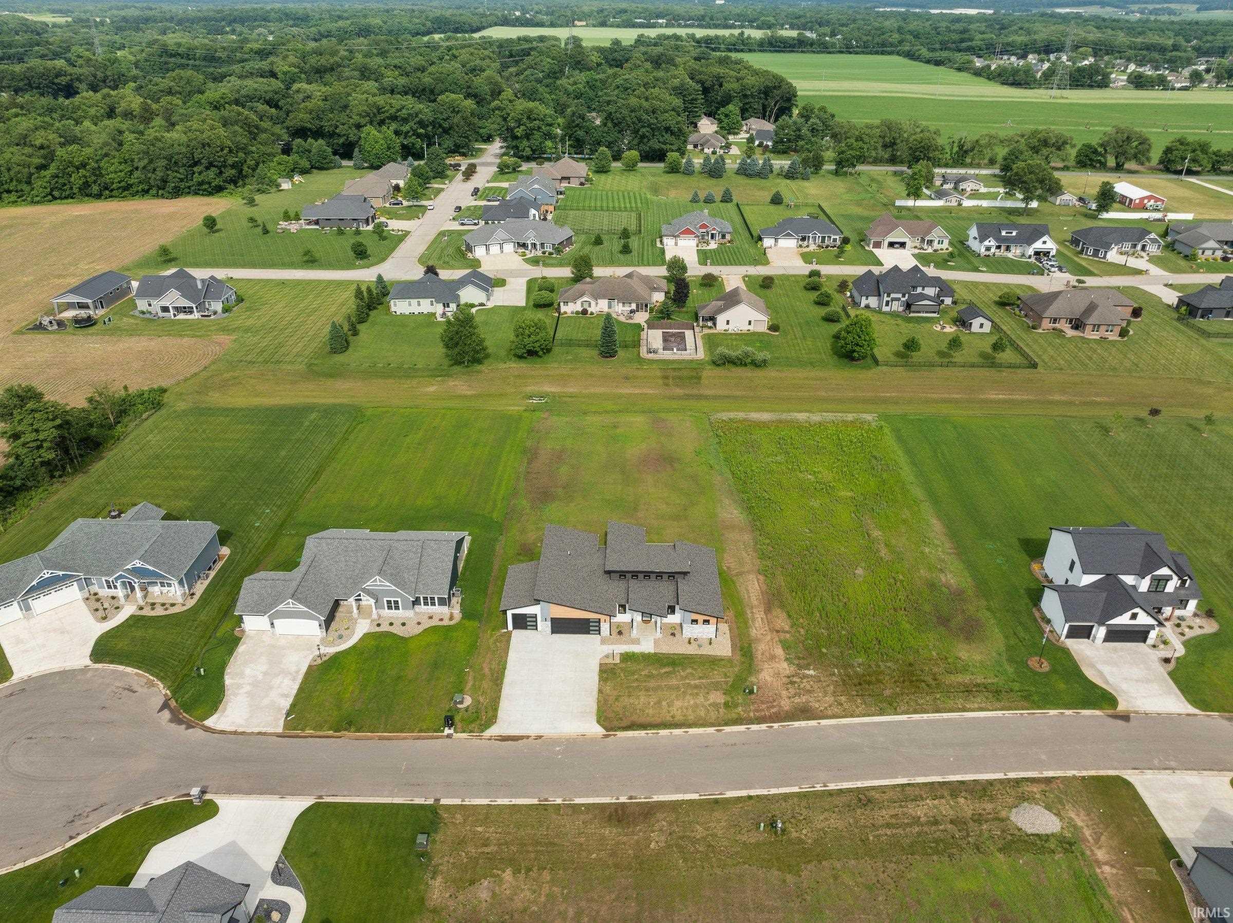 Aerial view of property's location with nearby suburban area