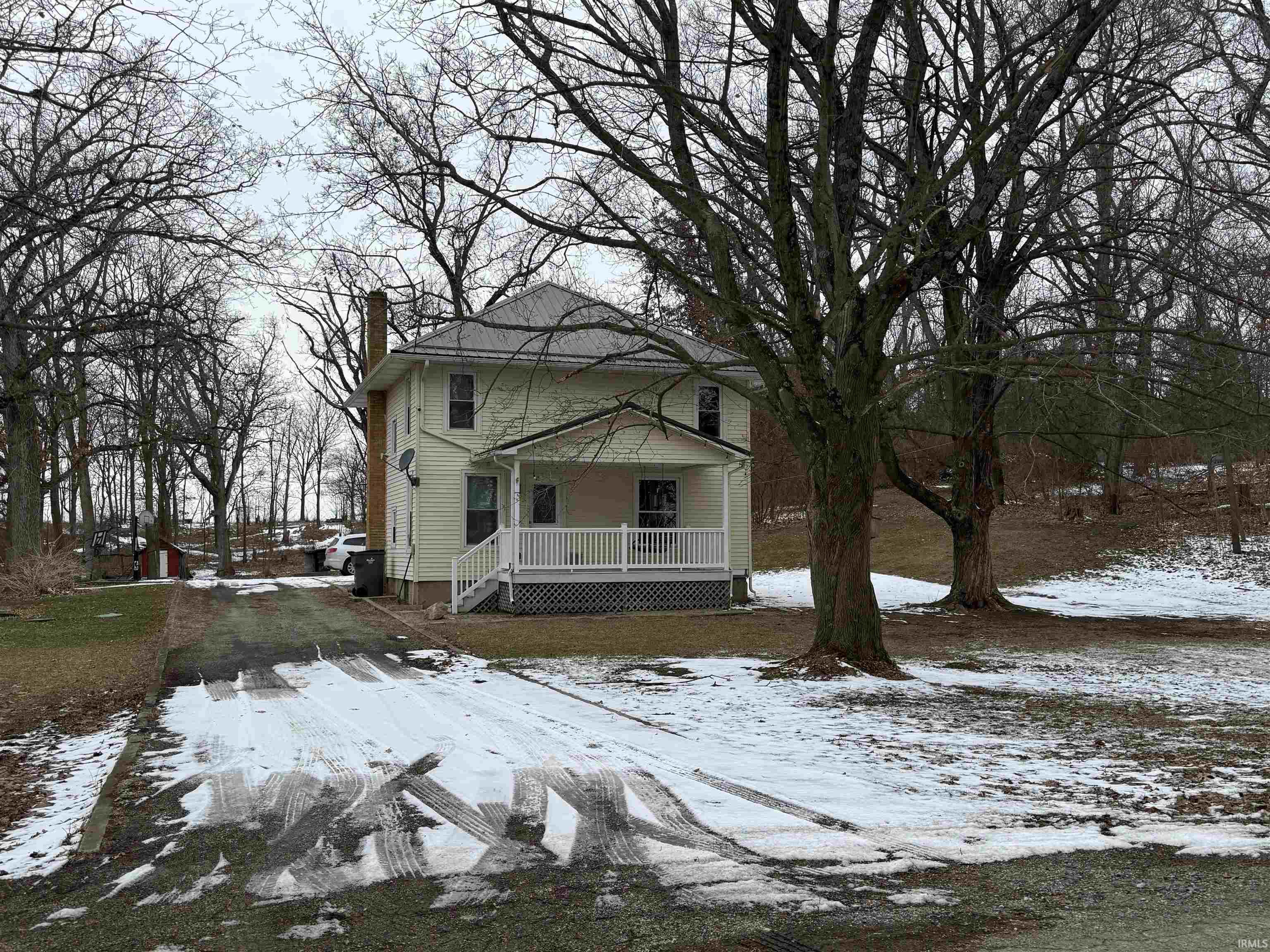 American foursquare style home featuring a chimney