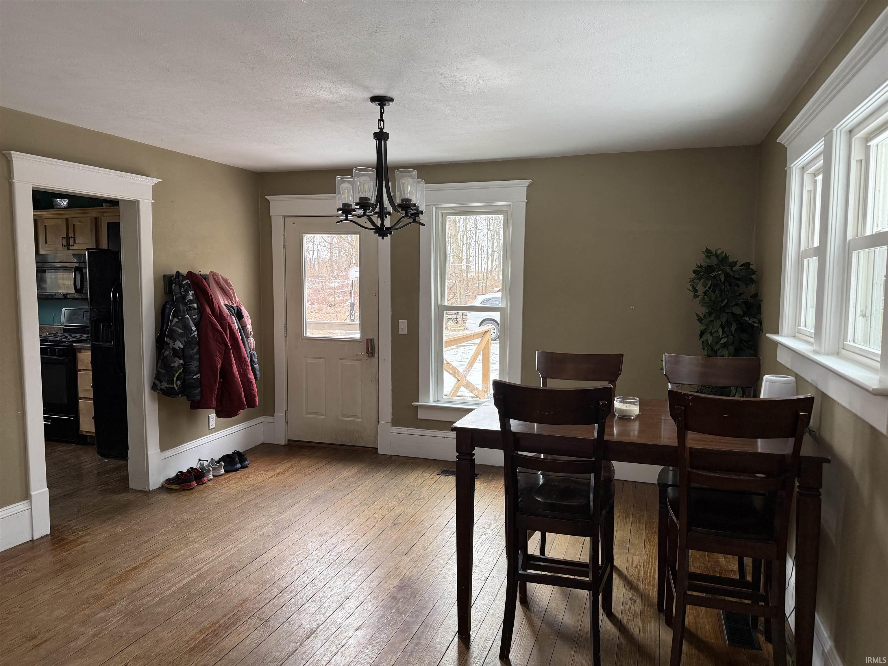 Dining room featuring hardwood / wood-style flooring and a chandelier