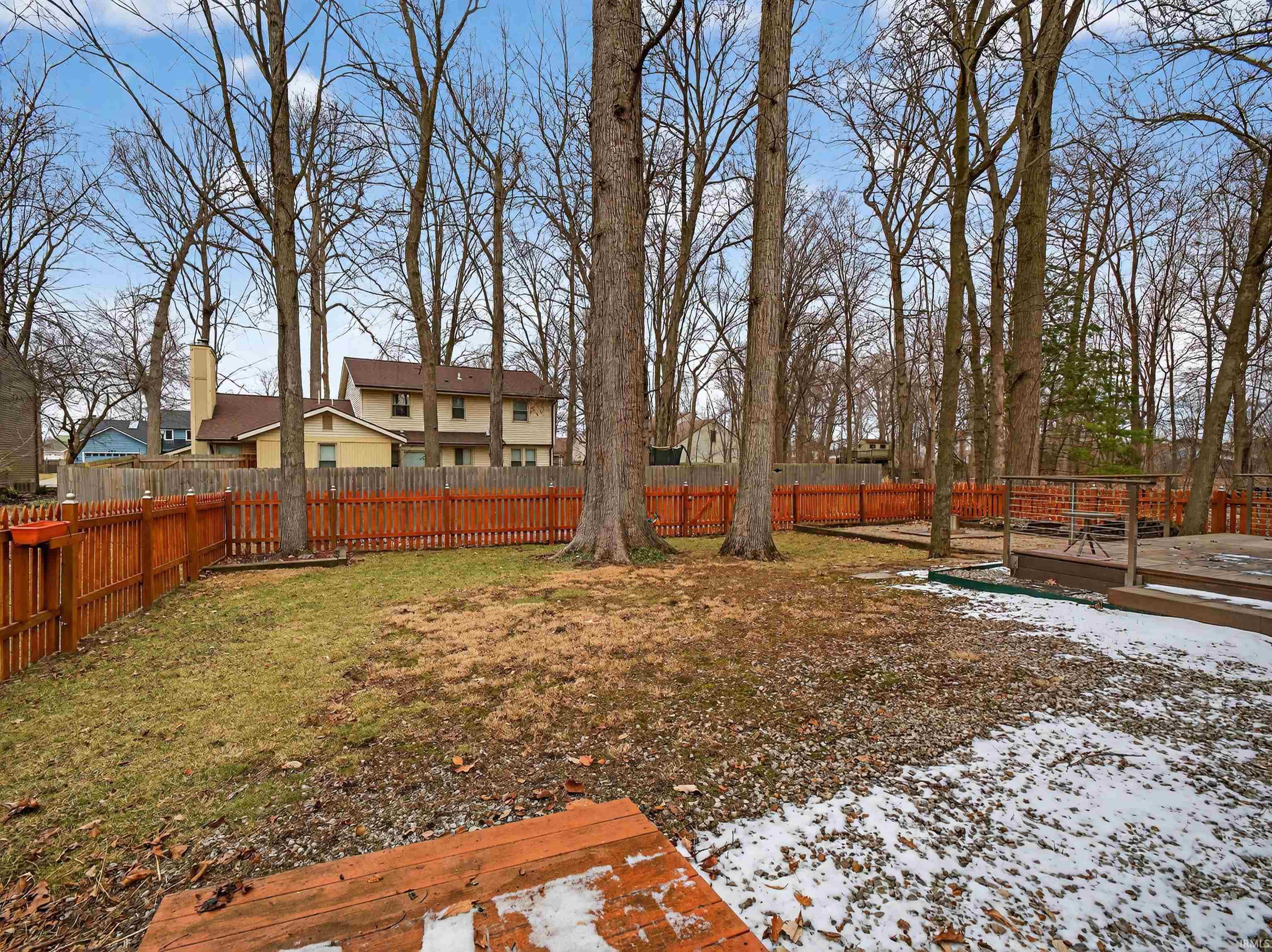 Fenced backyard featuring a deck