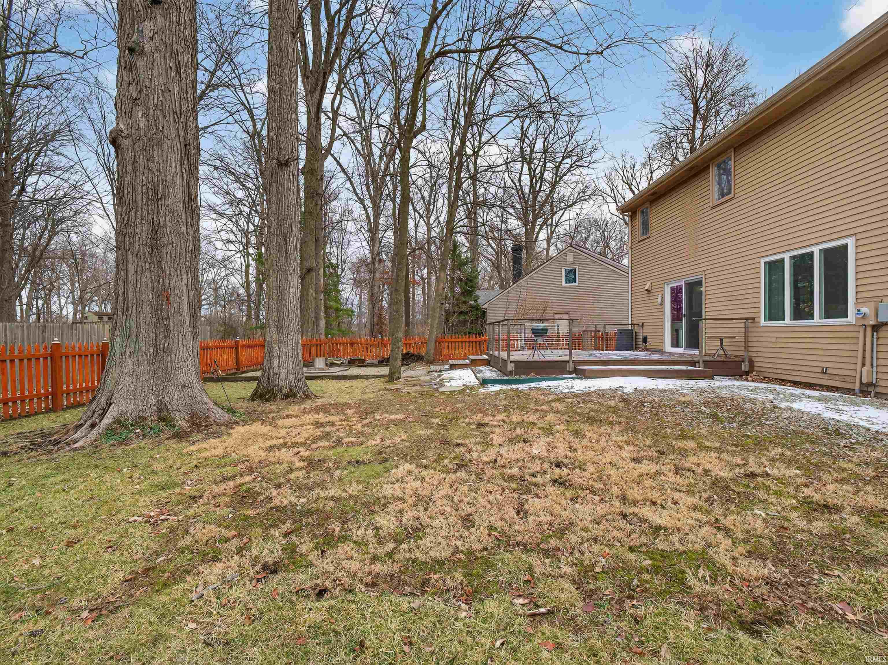 Fenced backyard featuring a wooden deck