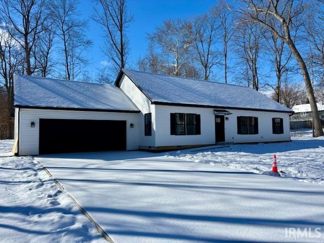 View of front of home with an attached garage and driveway