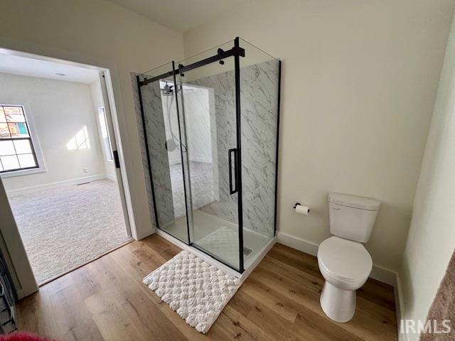 Full bathroom featuring a marble finish shower and light wood-type flooring