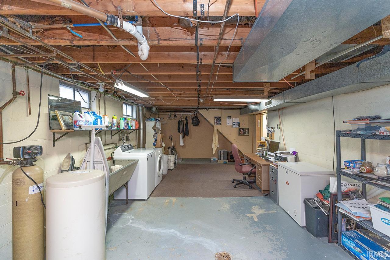 Basement with a water softener, washing machine and dryer, and an office area