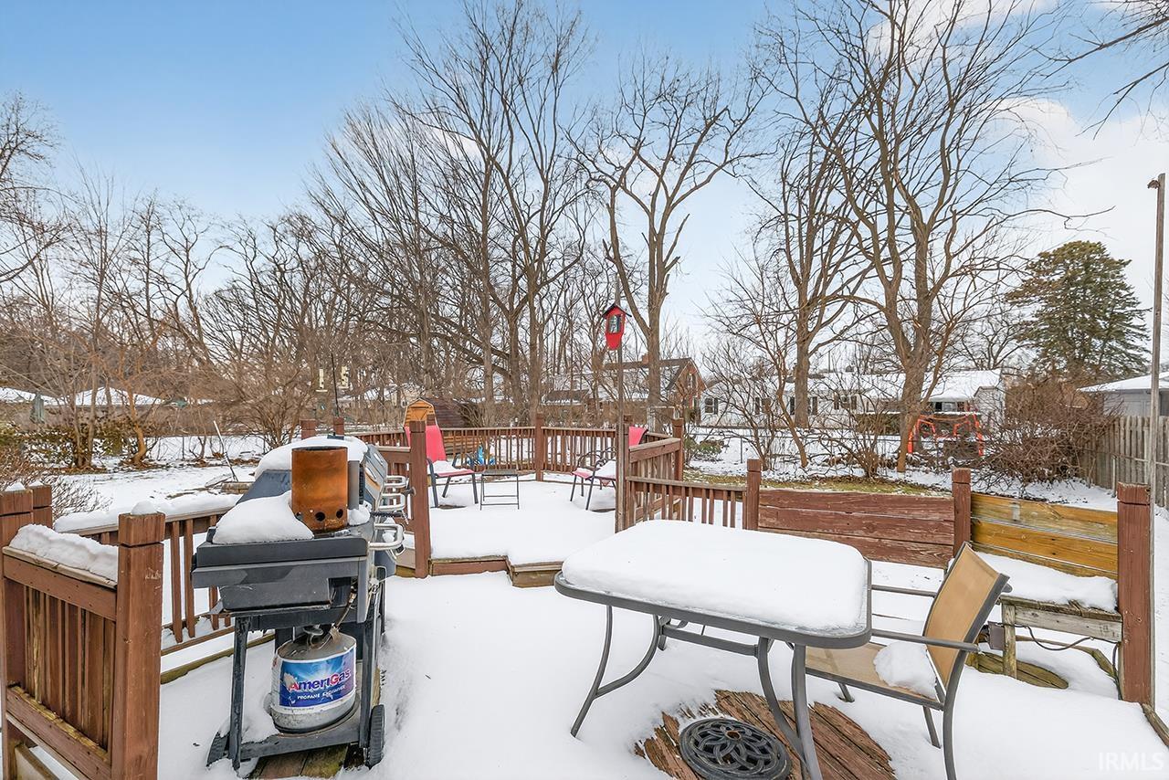 Snow covered deck with area for grilling