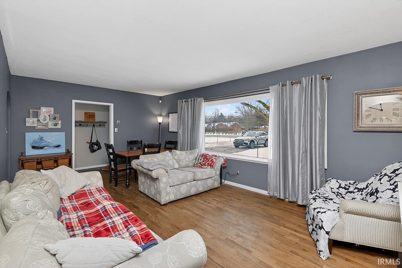 Living area with wood finished floors and baseboards