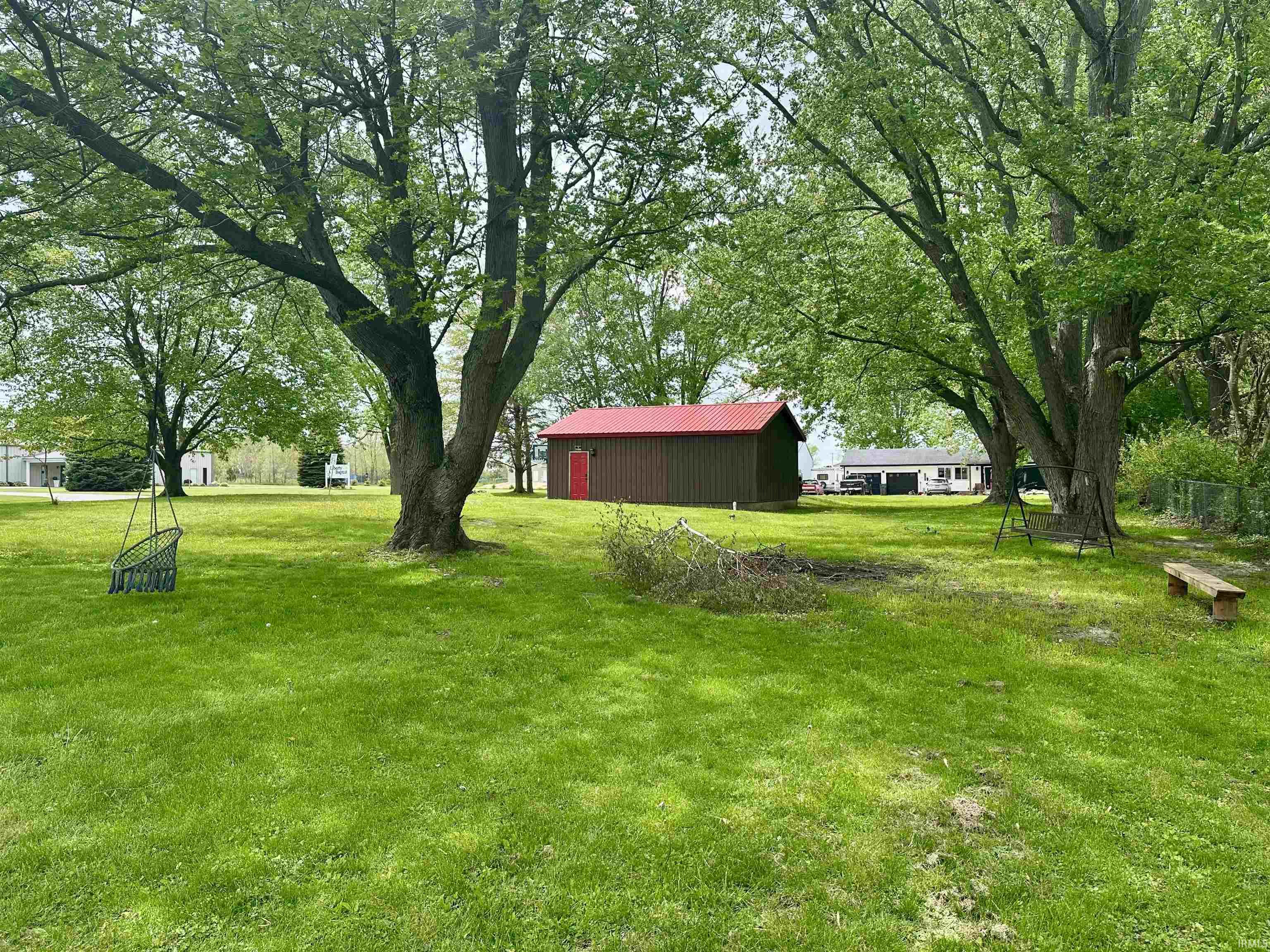 Expansive green lawn with mature trees providing extensive shade