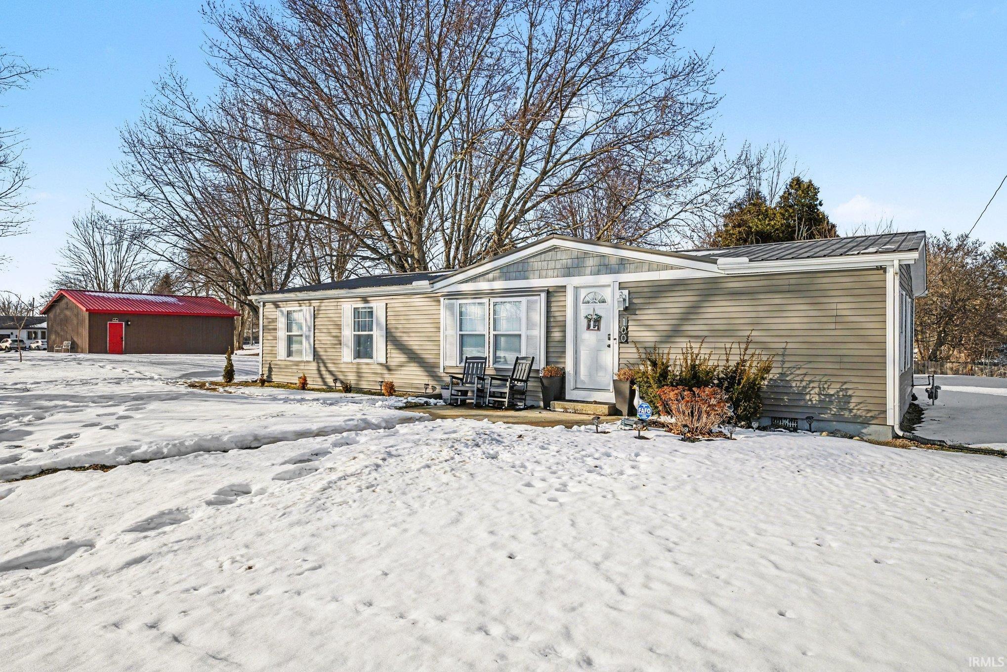 View of front of property with a patio area and a metal roof