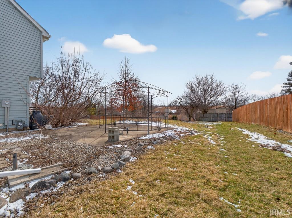 Yard covered in snow with a patio