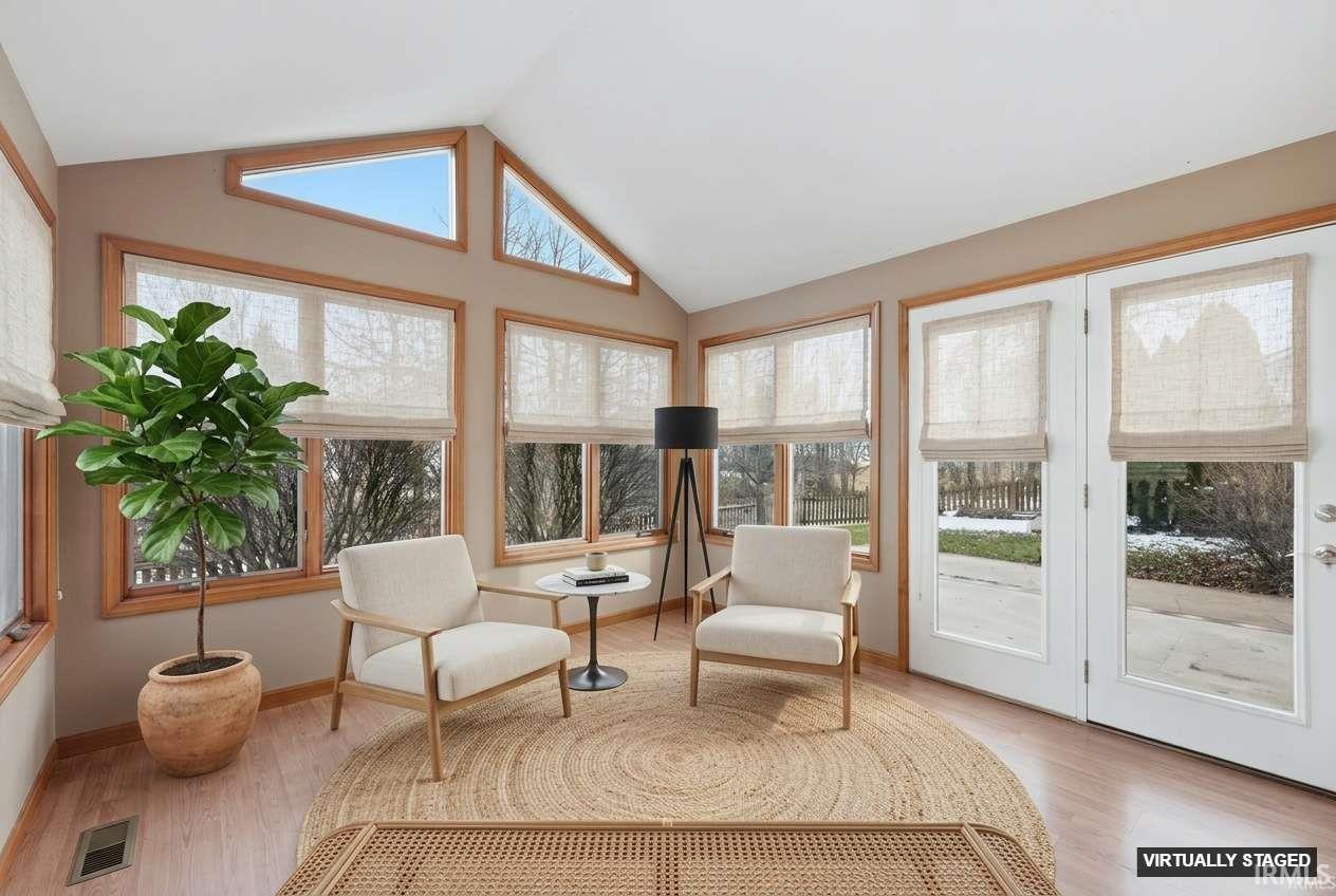 Sunroom / solarium featuring french doors and wood finished floors