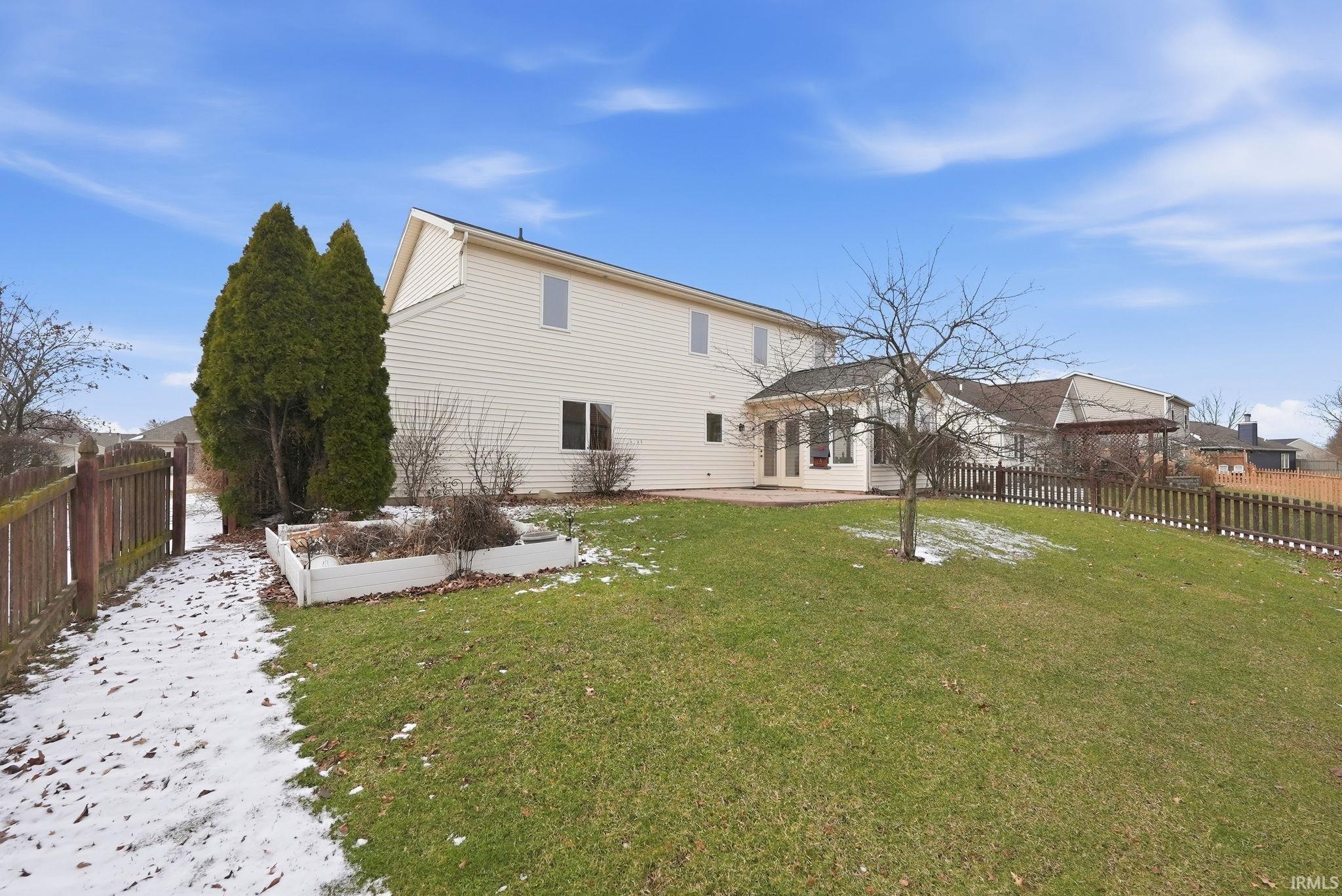 Back of house featuring a fenced backyard and a patio area
