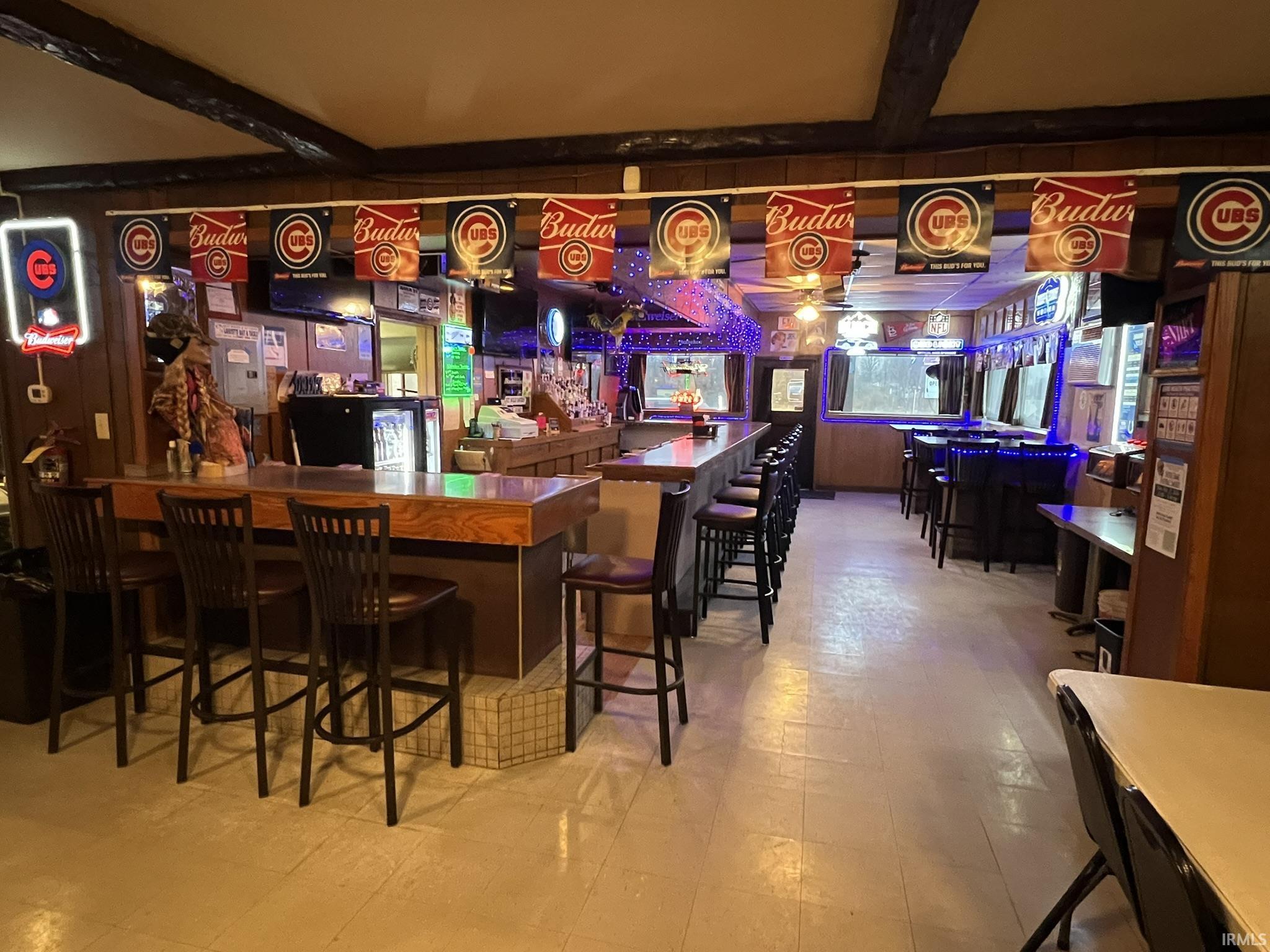 Indoor dry bar with beamed ceiling