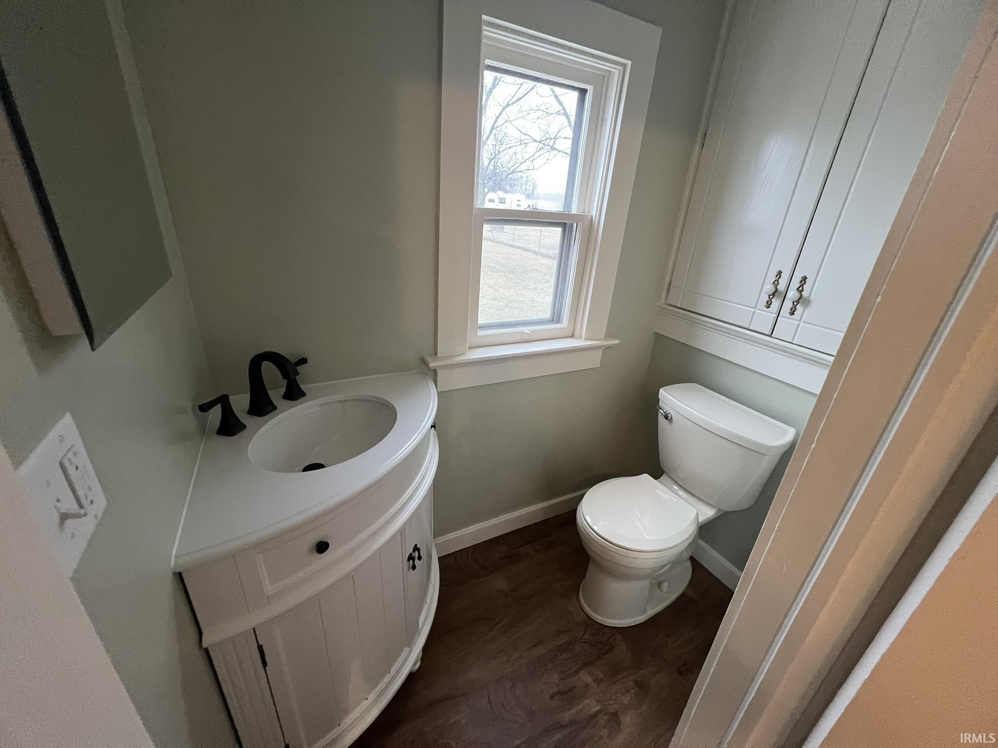 Bathroom featuring vanity and dark wood-style flooring