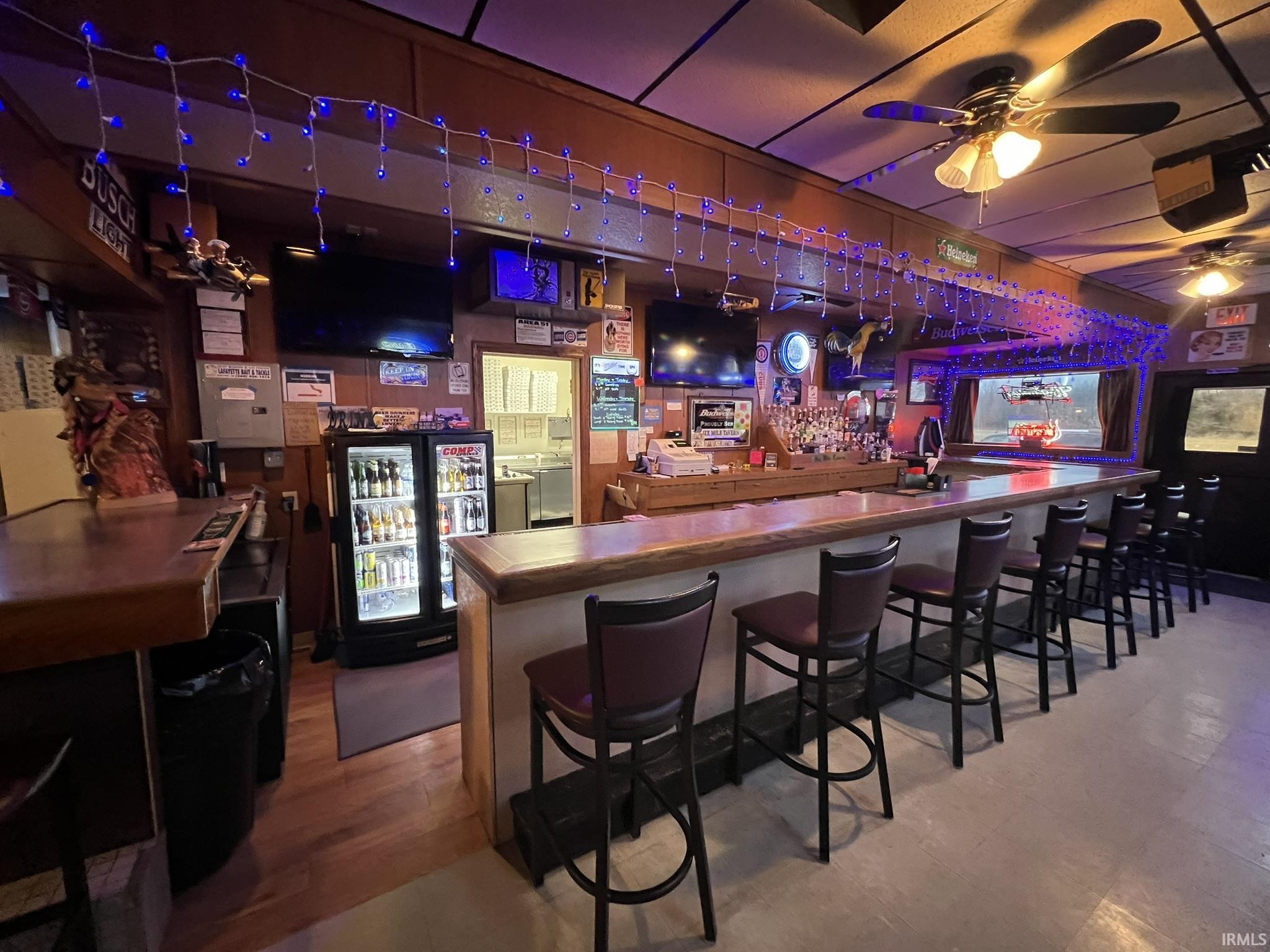 Indoor dry bar with ceiling fan and butcher block counters