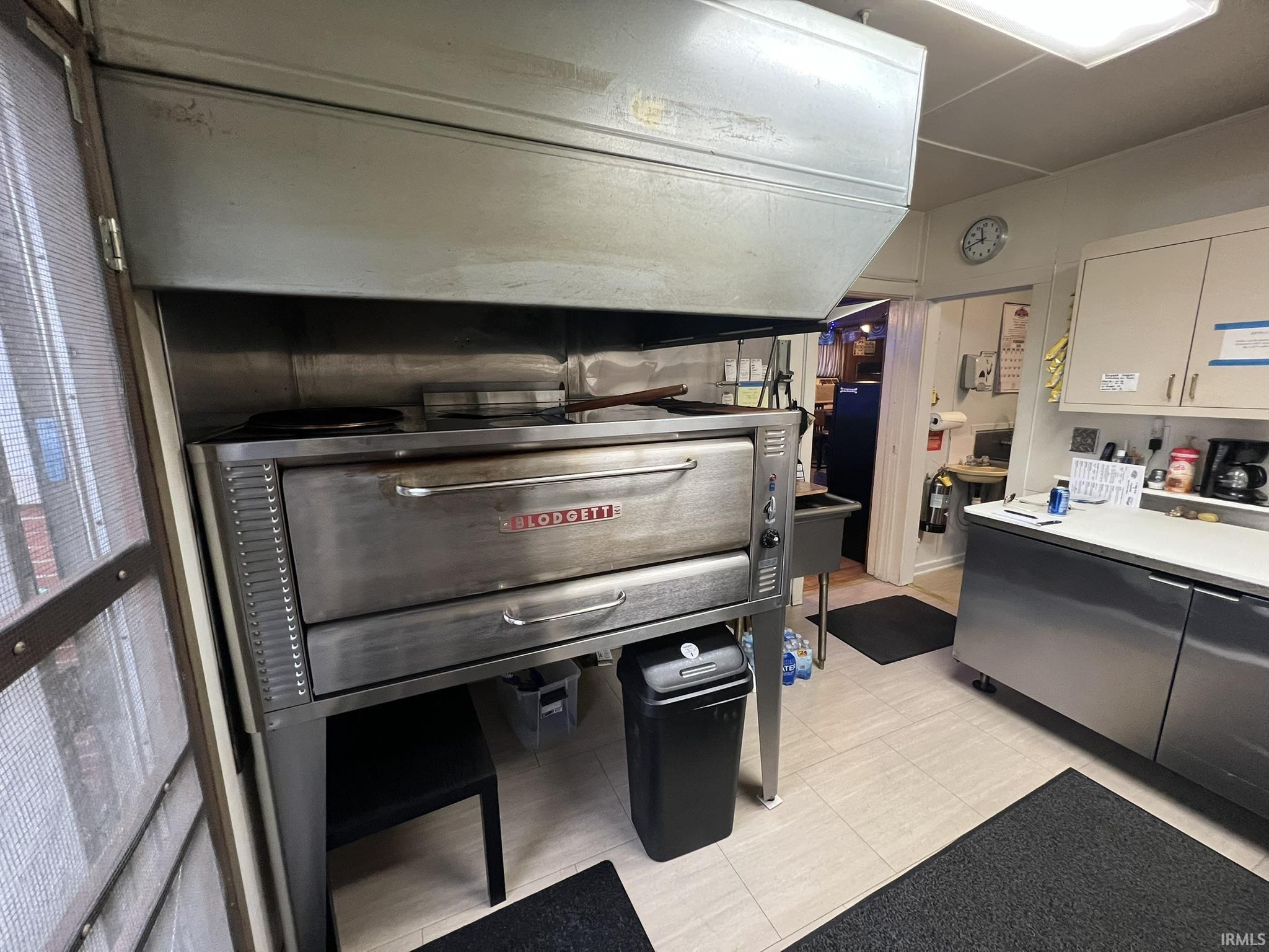 Kitchen featuring light countertops and stainless steel refrigerator