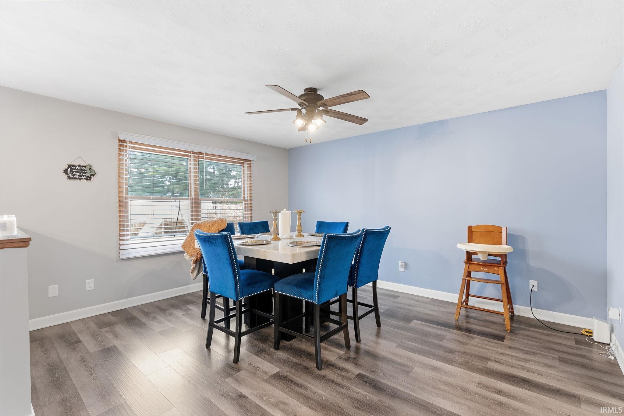 Dining area featuring wood finished floors and a ceiling fan