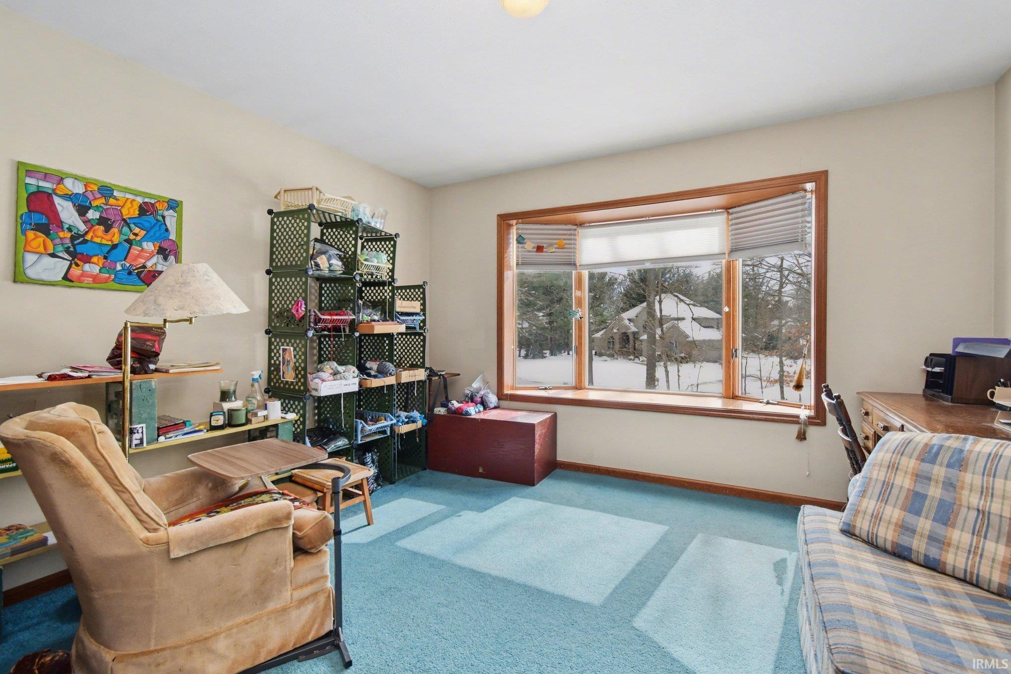 Home office featuring light carpet and baseboards